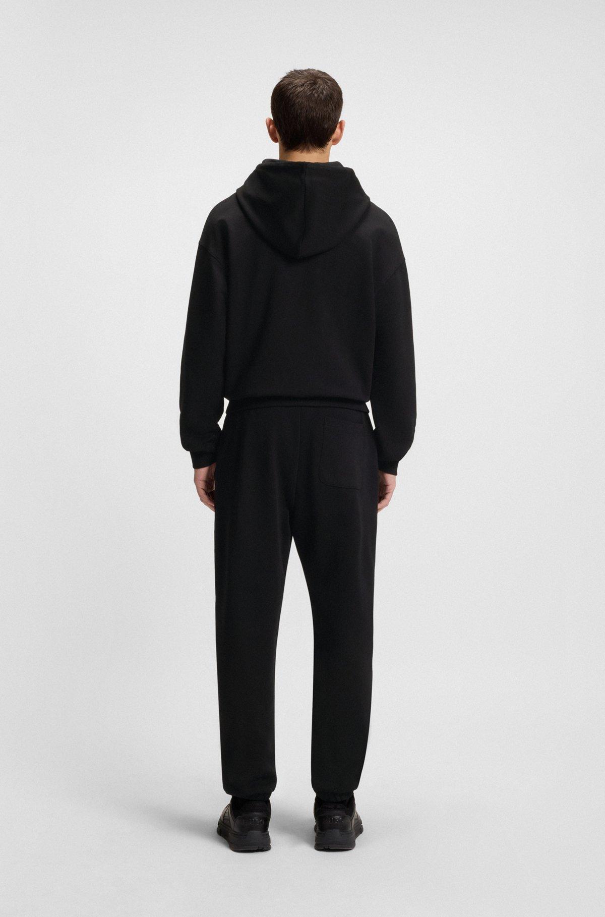 HUGO - Cotton-terry tracksuit bottoms with split logo - Black Product Image