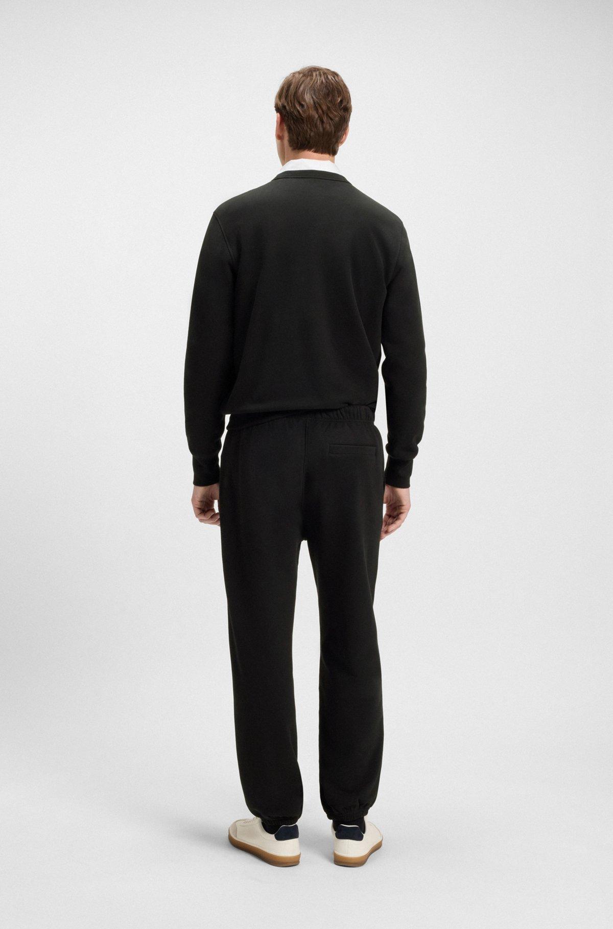 BOSS - BECKHAM x BOSS relaxed tracksuit bottoms in cotton terry - Black Product Image