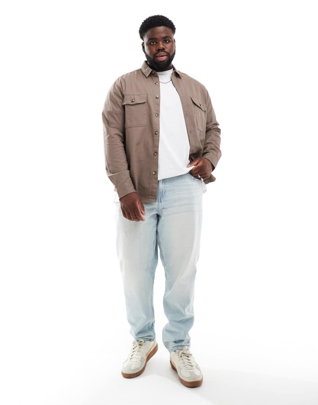 ASOS DESIGN tapered fit jeans in light wash blue Product Image