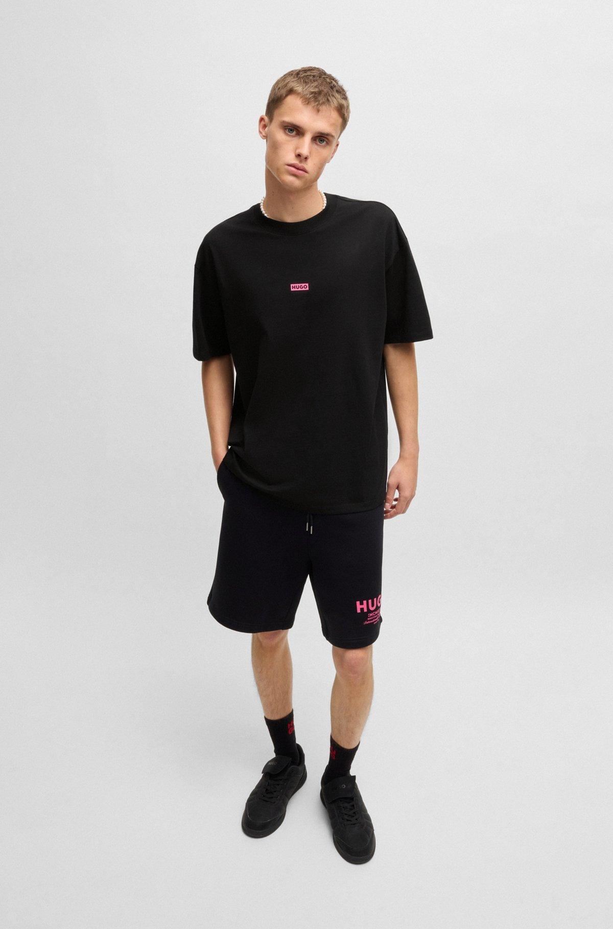 HUGO - Loose-fit T-shirt in cotton with rear logo artwork - Black Product Image