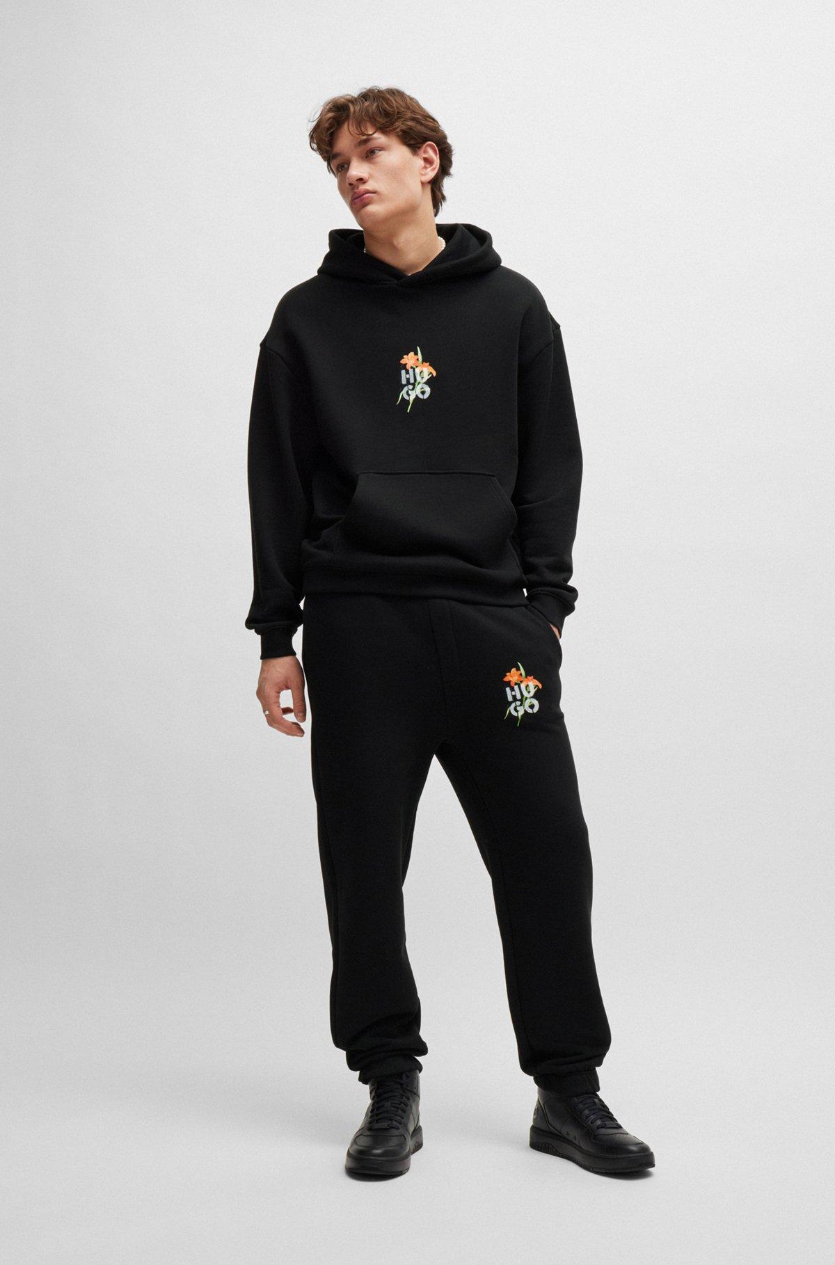 Relaxed-fit tracksuit bottoms with floral logo artwork Product Image