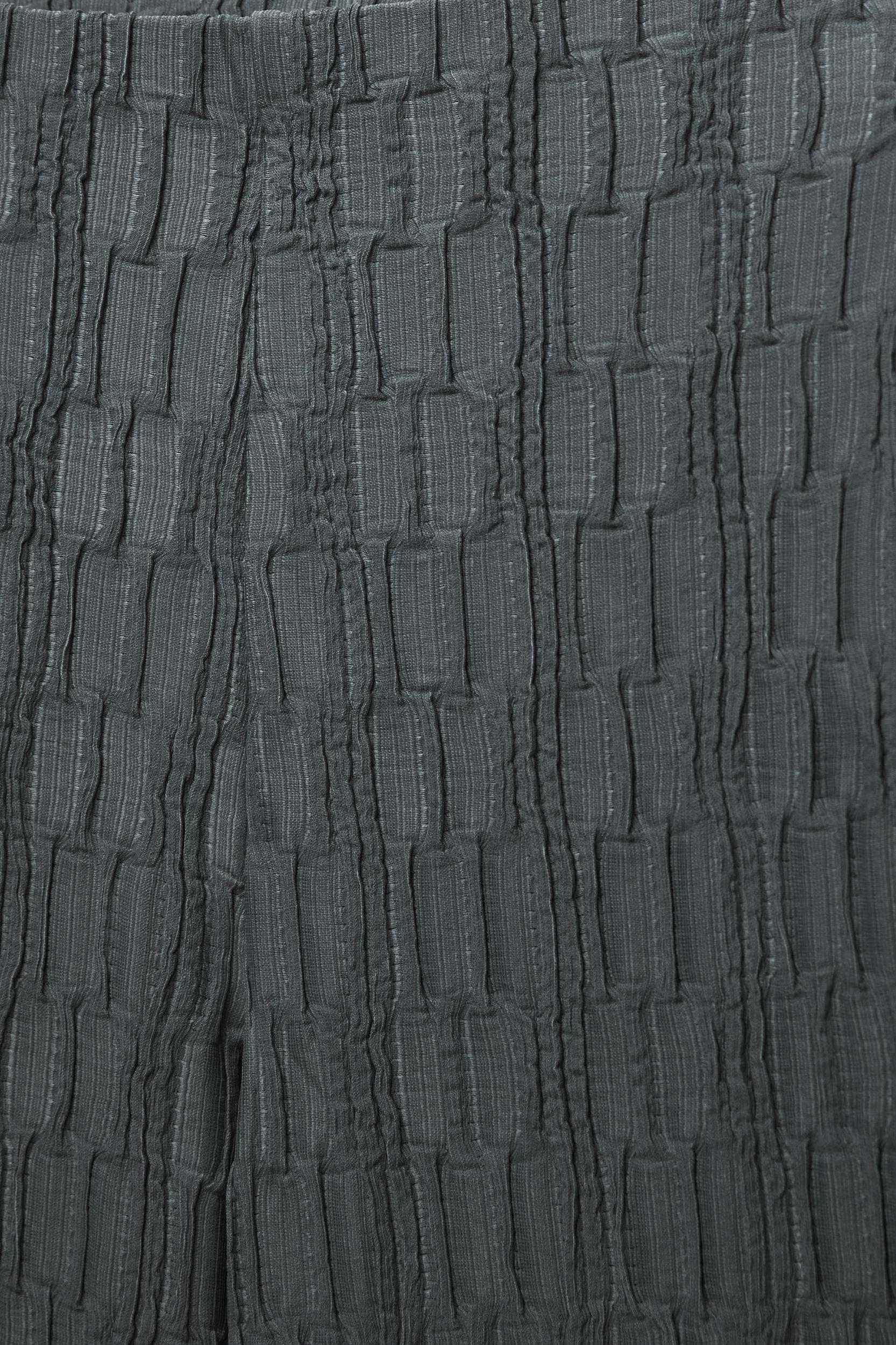 Textured bell bottom trousers Product Image