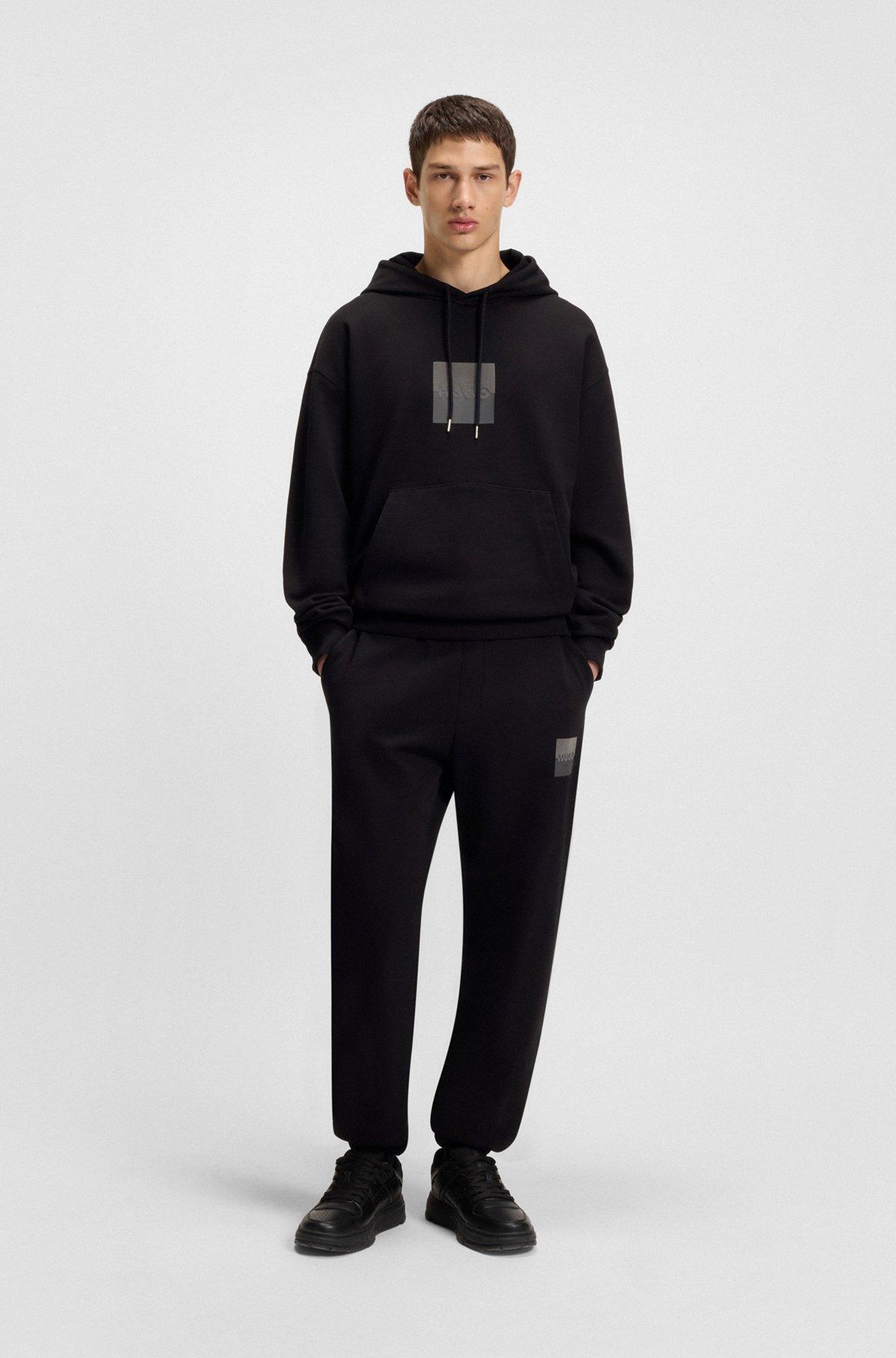 HUGO - Cotton-terry tracksuit bottoms with split logo - Black Product Image