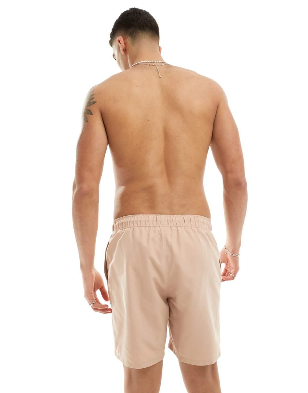 ASOS DESIGN swim shorts in mid length in beige Product Image