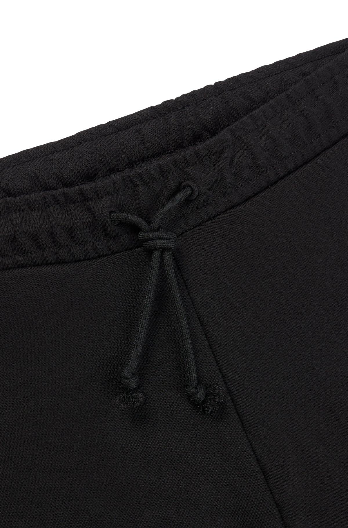 Relaxed-fit cotton-terry tracksuit bottoms with stacked logo Product Image