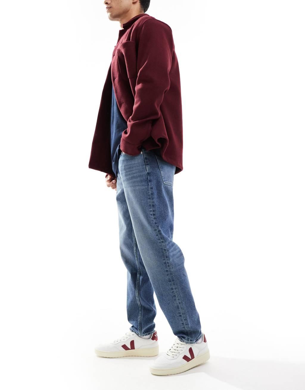 ASOS DESIGN tapered fit jeans in mid wash blue | ASOS Product Image