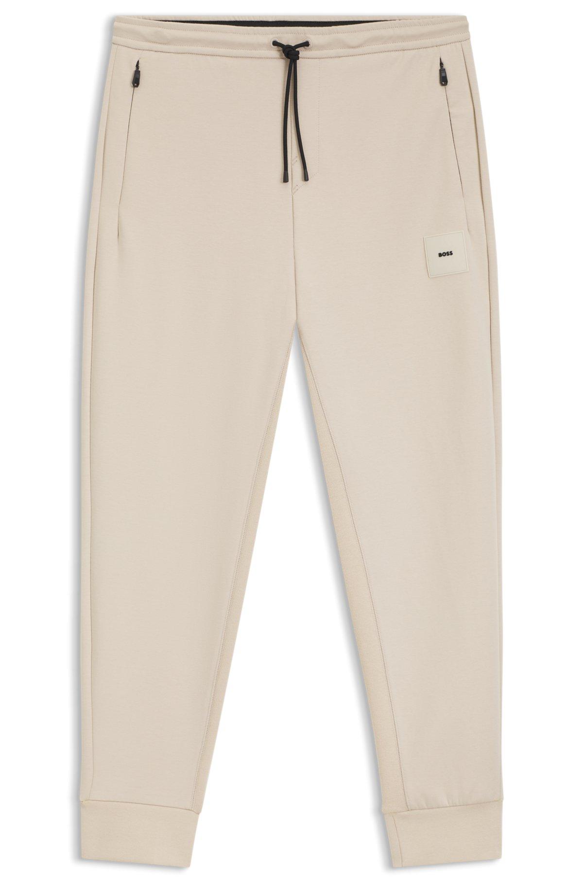 Stretch tracksuit bottoms with logo patch Product Image