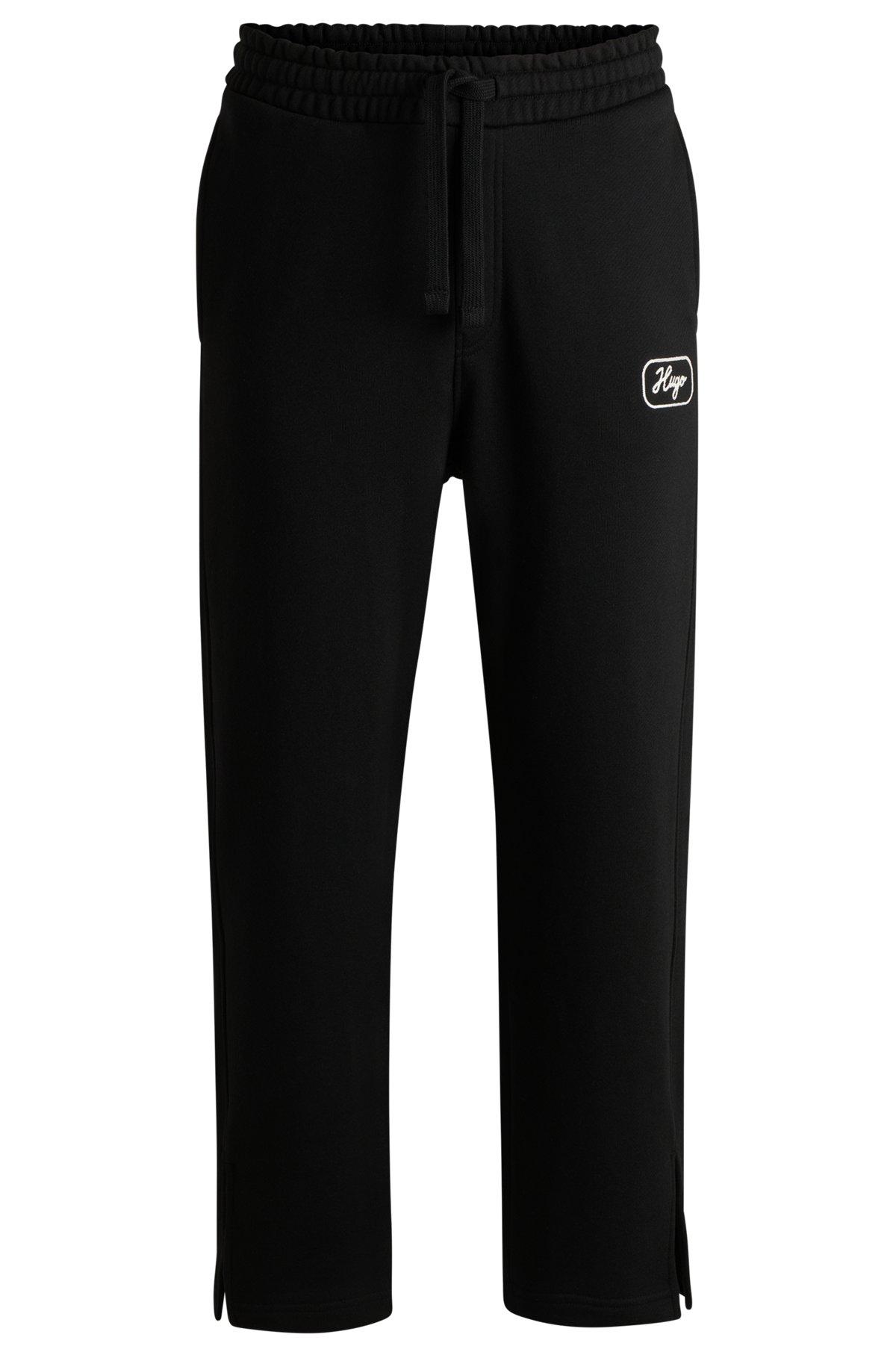 Cotton-terry tracksuit bottoms with embroidered graphics Product Image