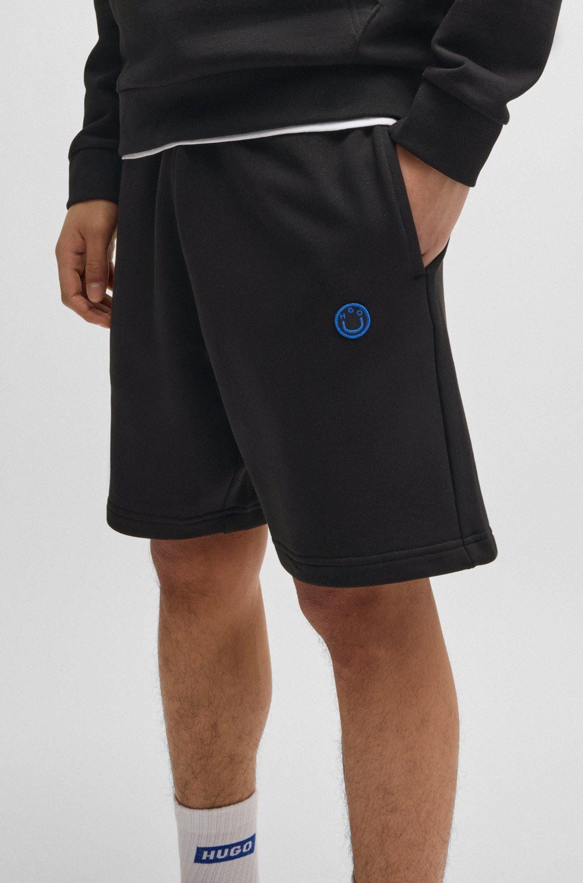 Cotton-terry shorts with Happy HUGO logo Product Image