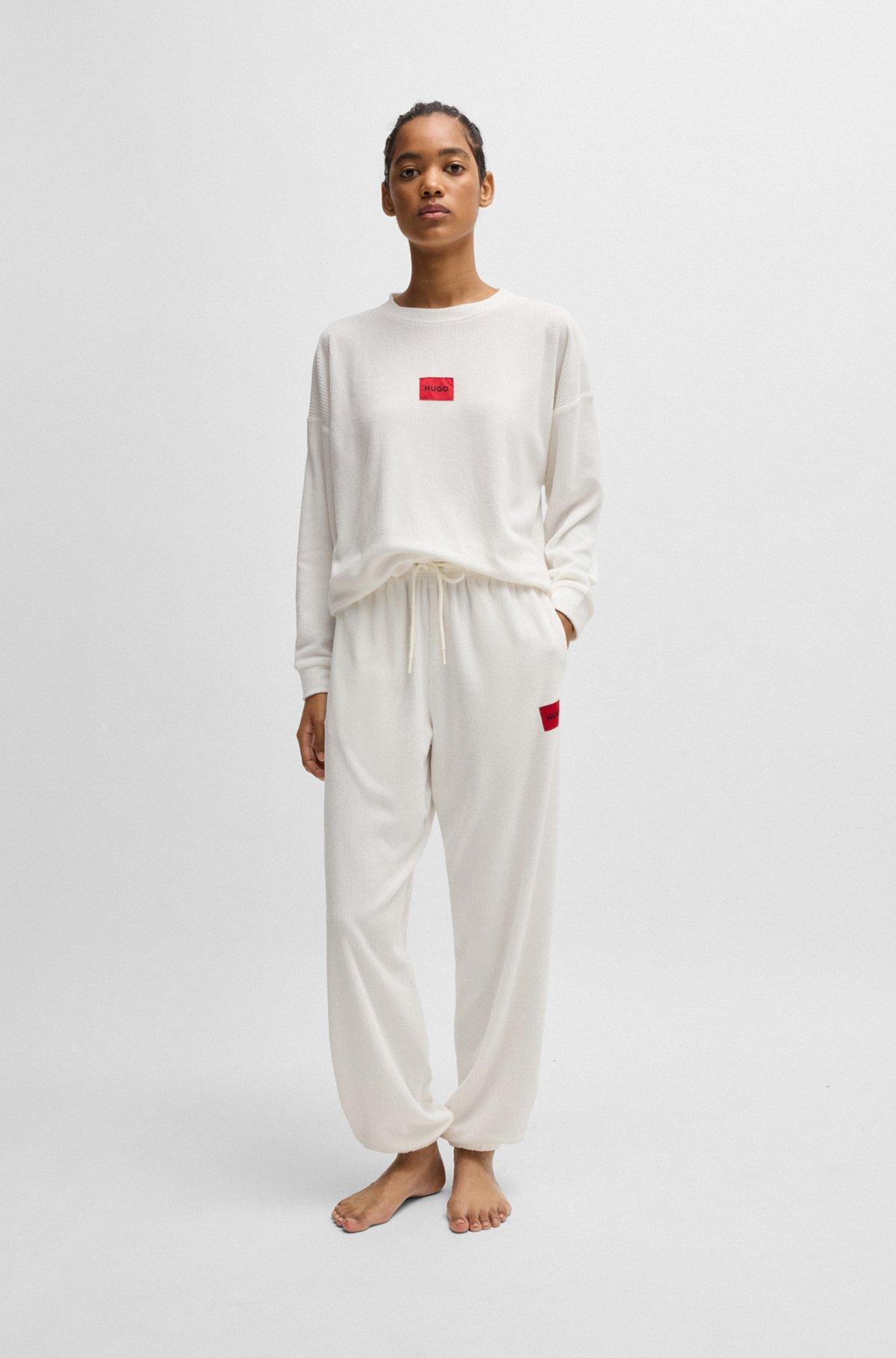 Tracksuit bottoms with red logo label Product Image