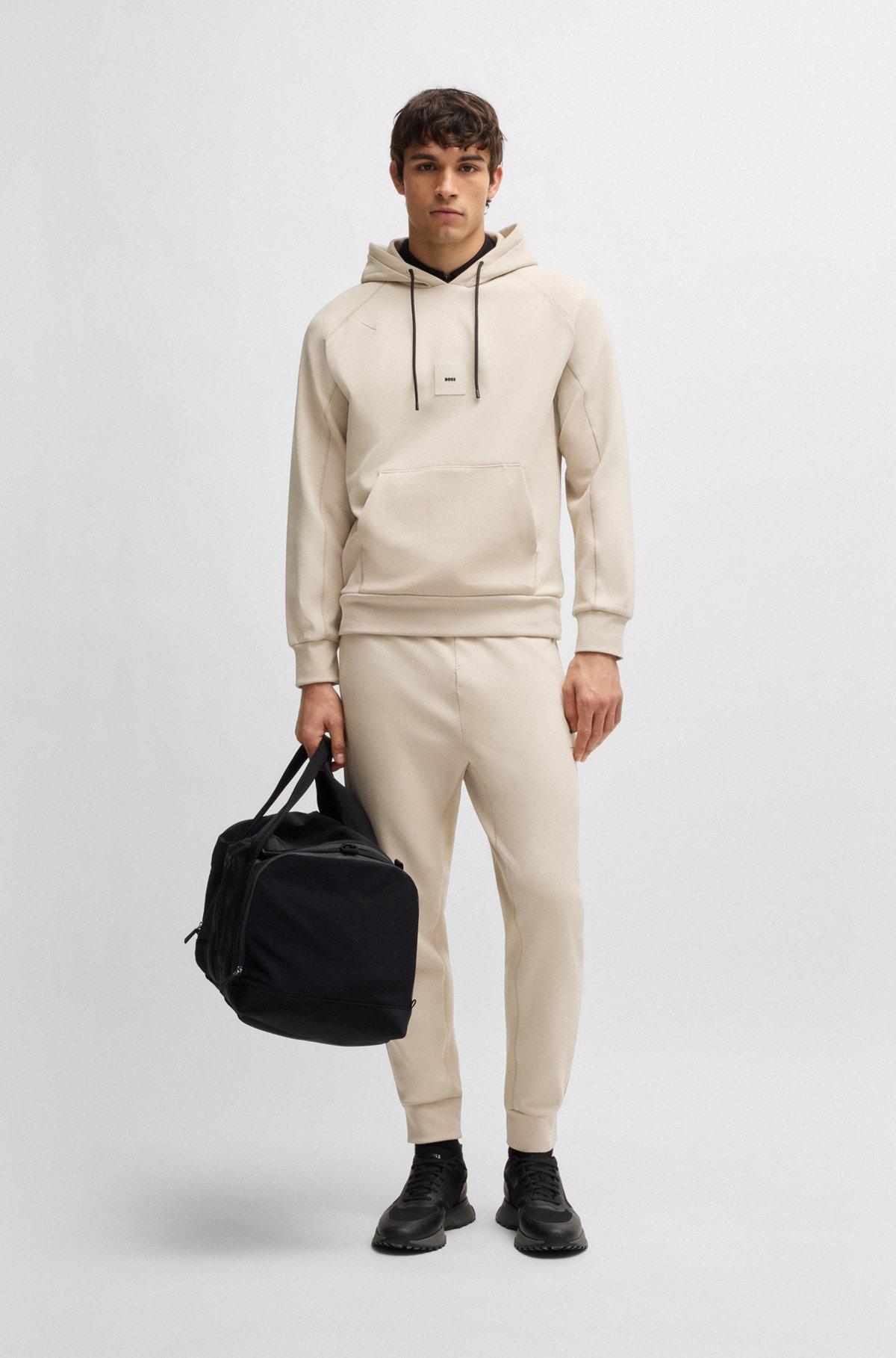Stretch tracksuit bottoms with logo patch Product Image
