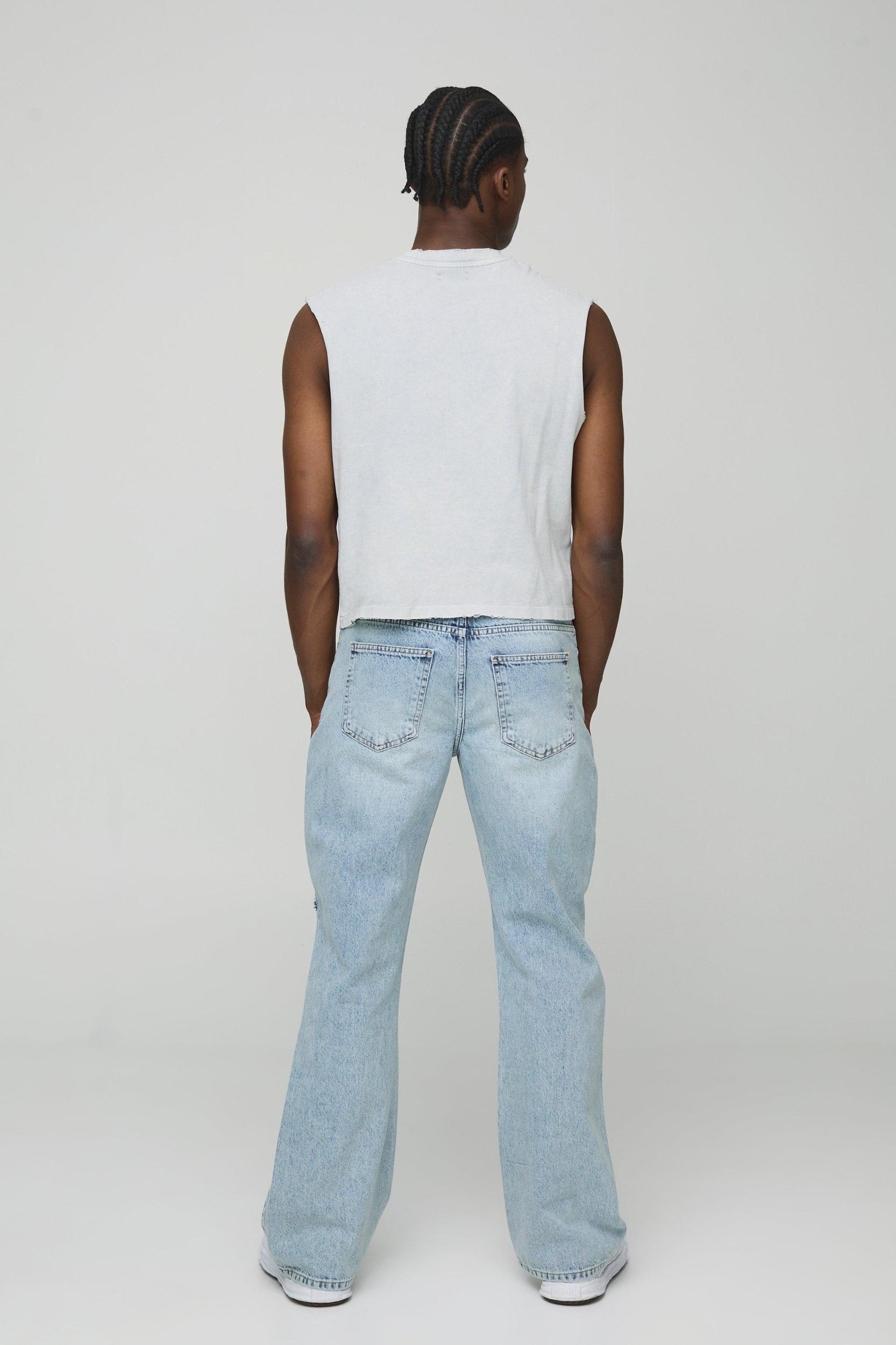 Relaxed Flare Ripped Knee Blue Wash Jeans | boohooMAN USA Product Image
