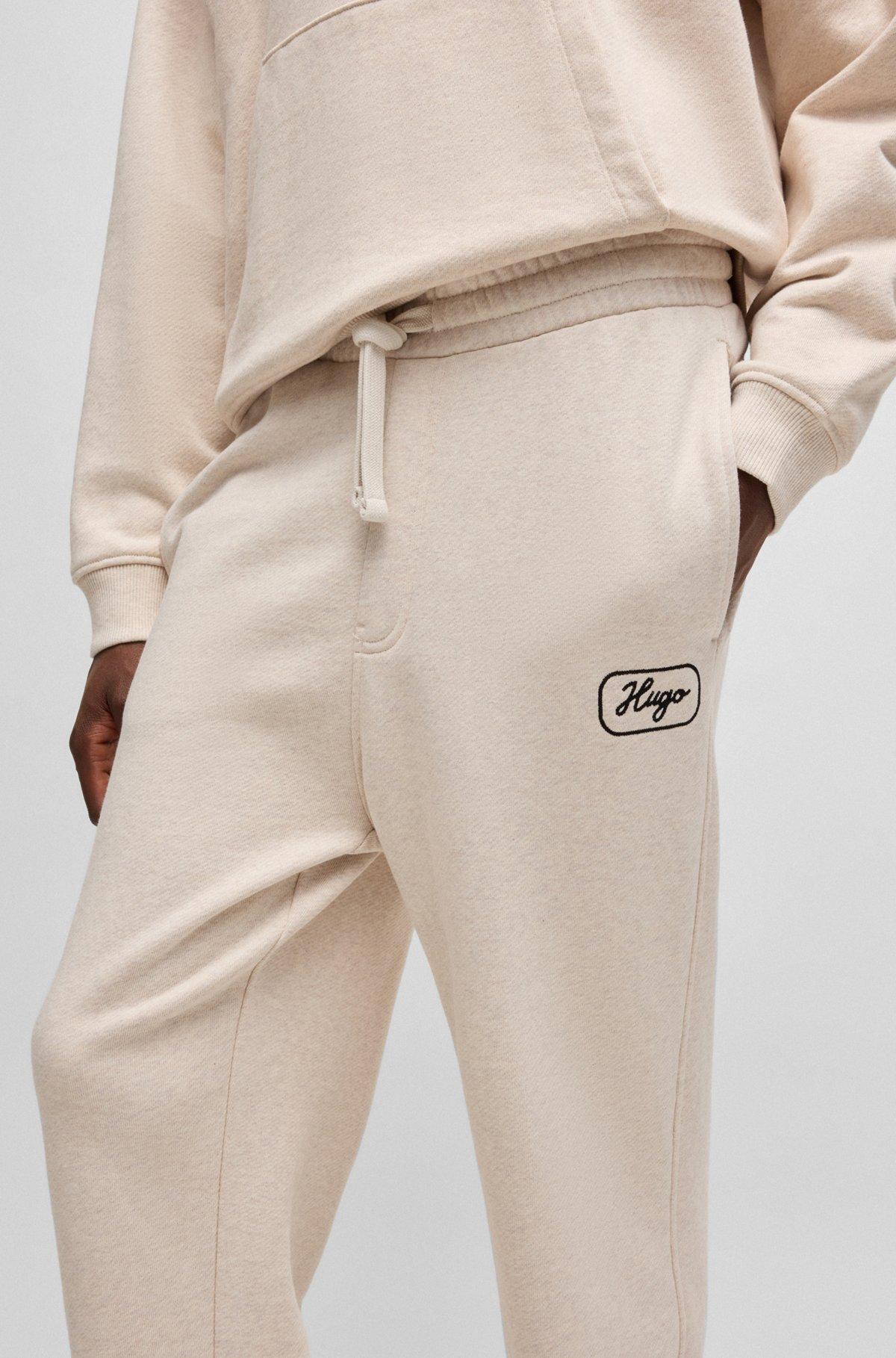 Cotton-terry tracksuit bottoms with embroidered graphics Product Image