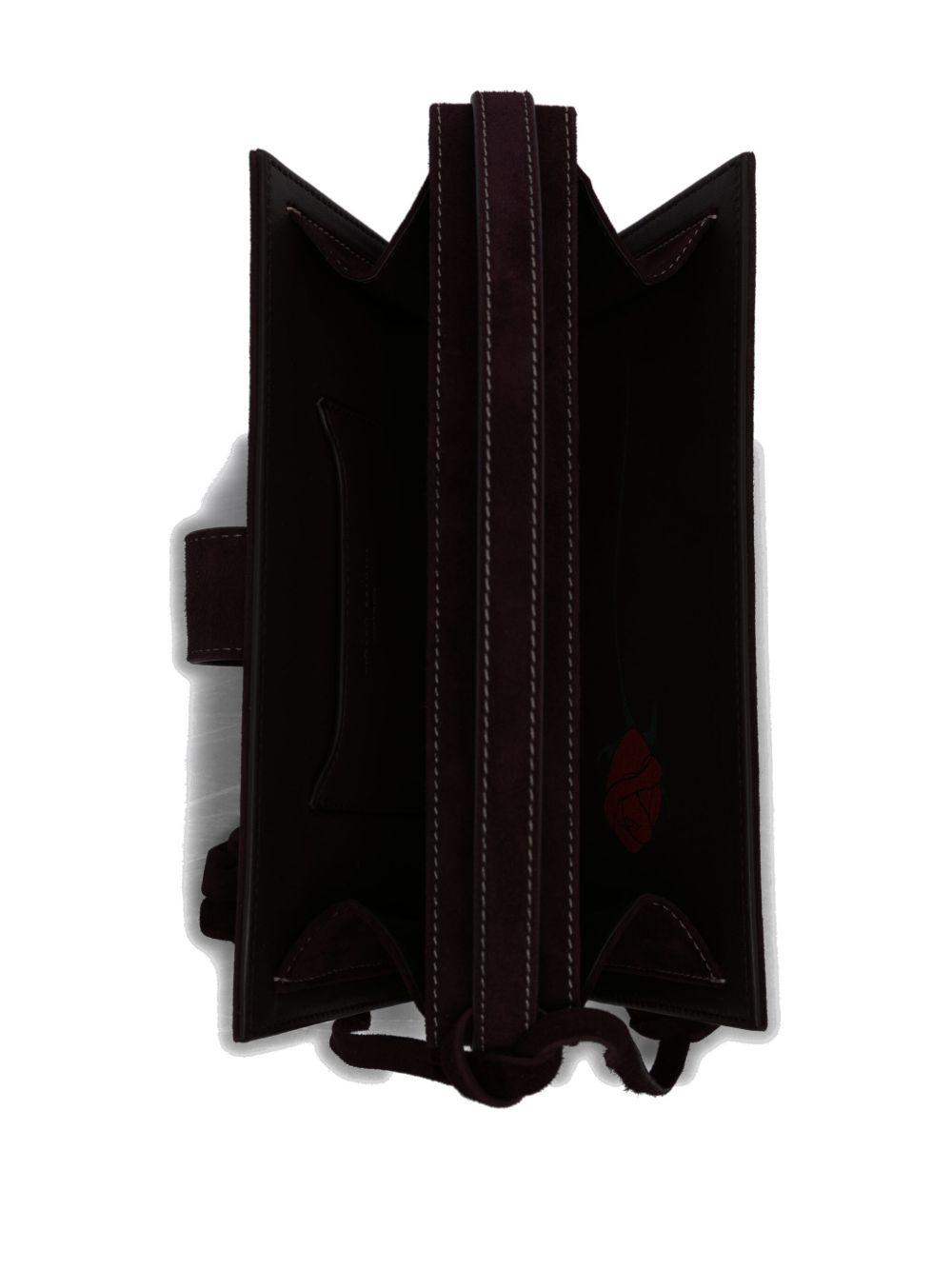 Apolonia rose-embellished suede clutch bag Product Image