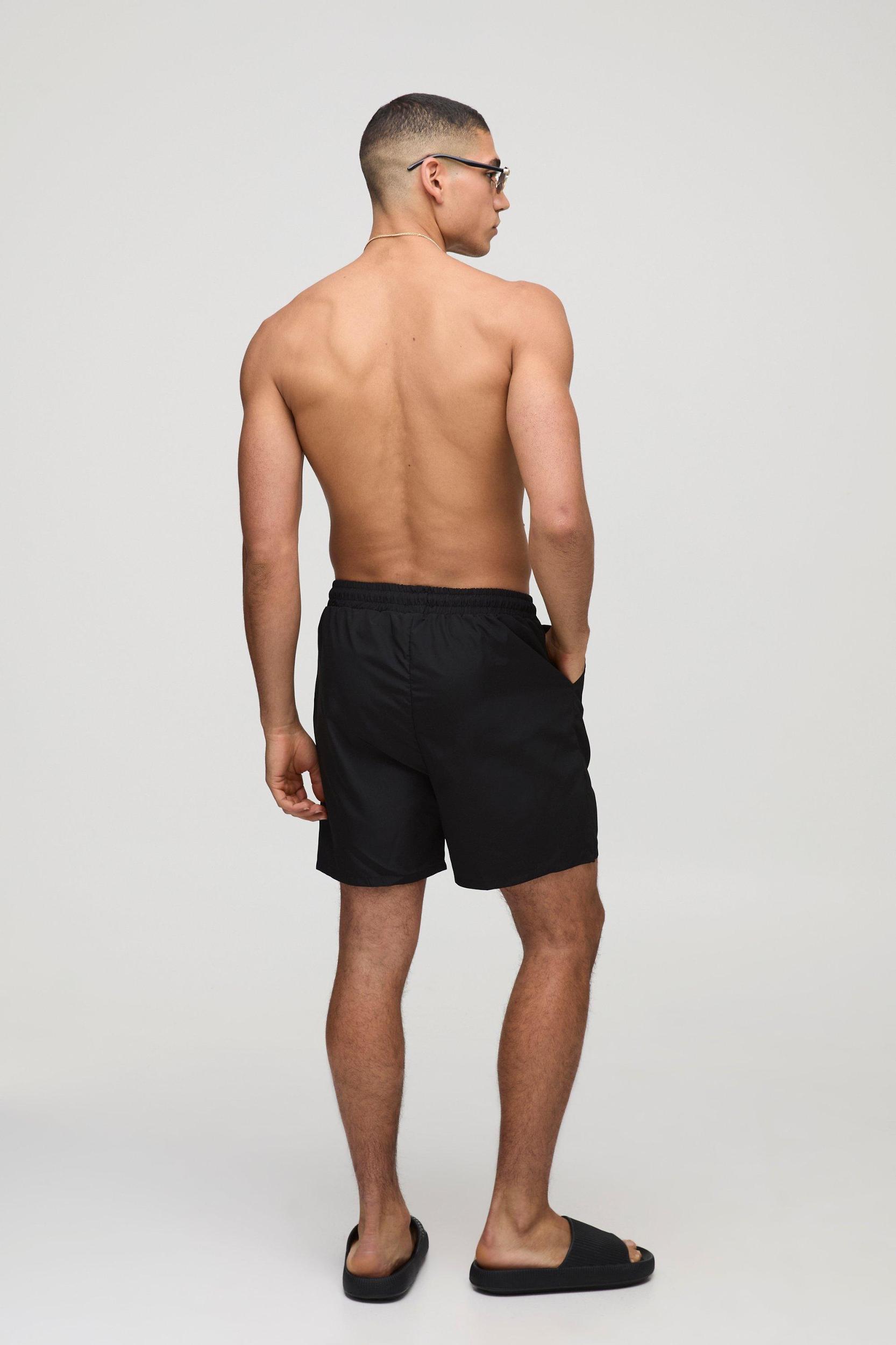 Branded Regular fit Mid length Embroidered Swim Shorts | boohooMAN USA Product Image