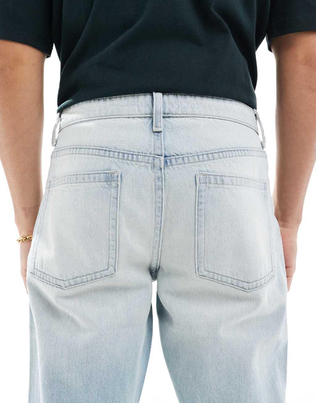 ASOS DESIGN tapered fit jeans in light wash blue Product Image