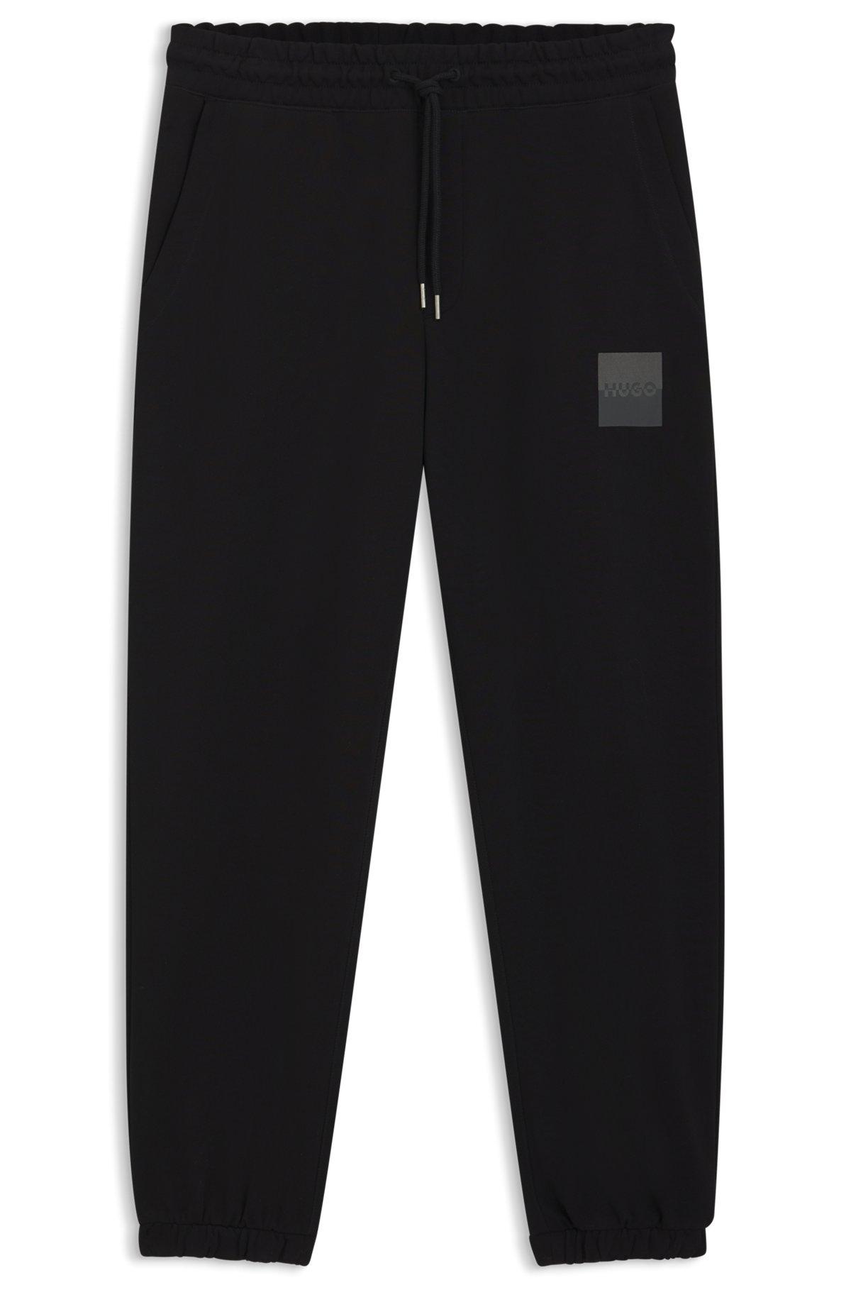 HUGO - Cotton-terry tracksuit bottoms with split logo - Black Product Image