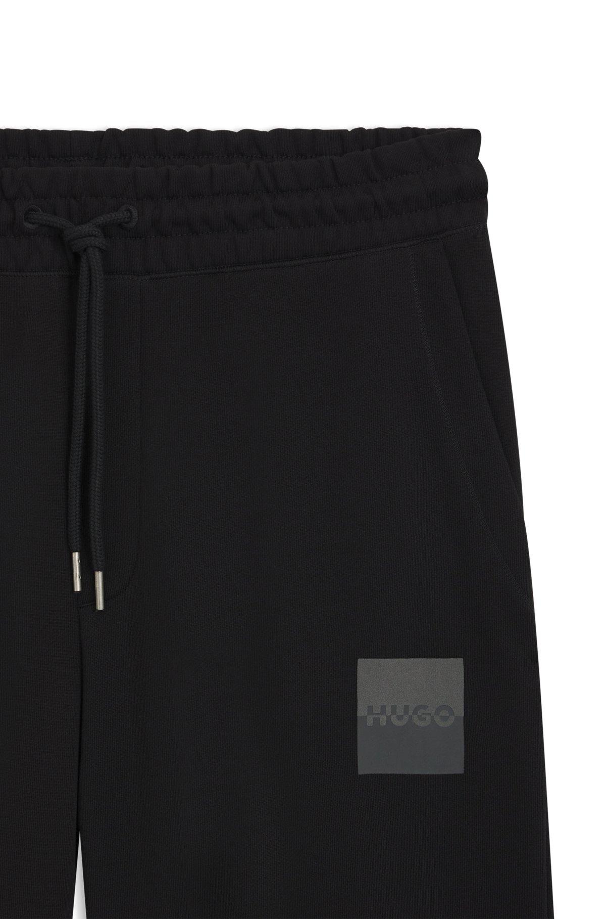HUGO - Cotton-terry tracksuit bottoms with split logo - Black Product Image