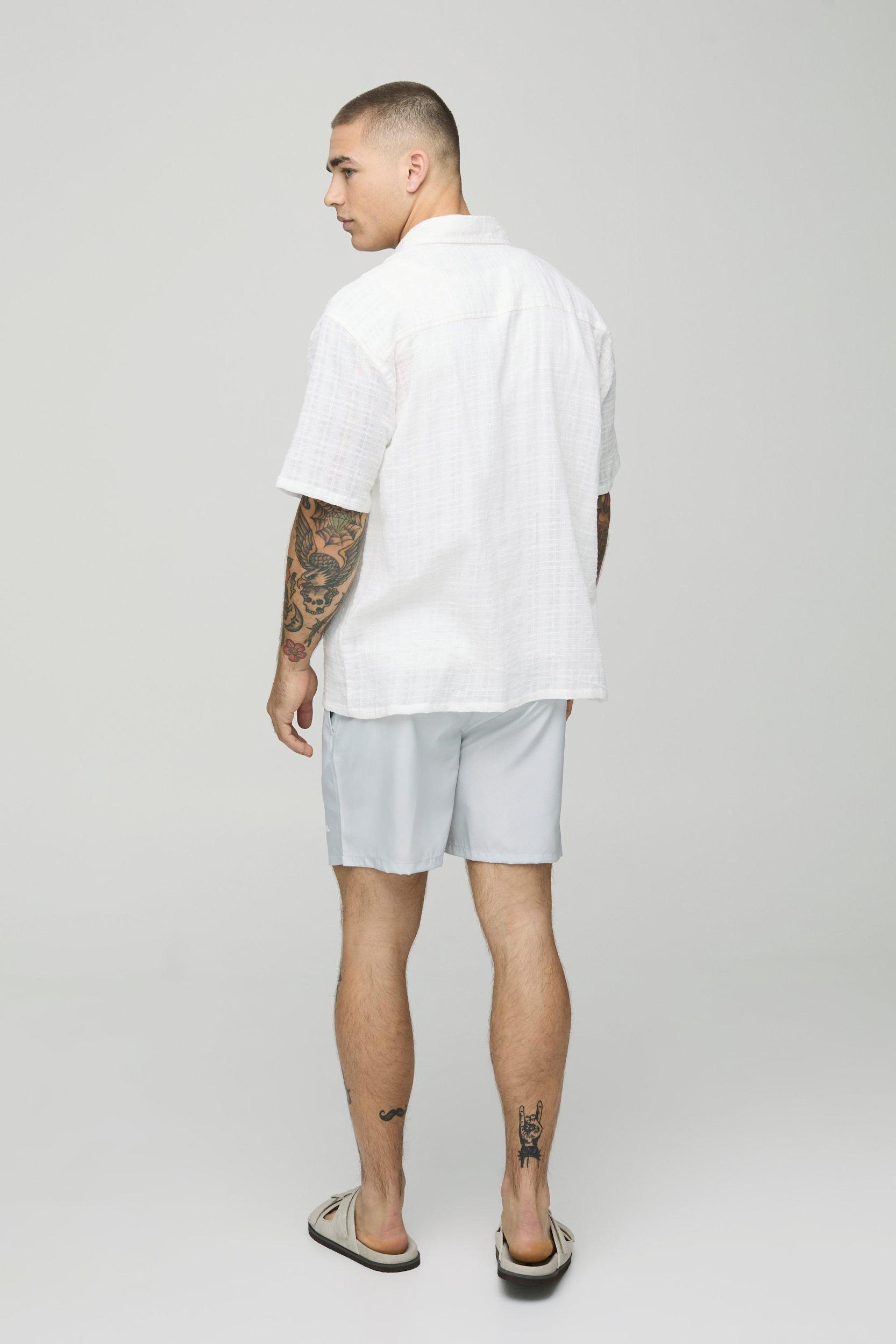 Mid Length Official Man Branded Swim Trunks | boohooMAN USA Product Image