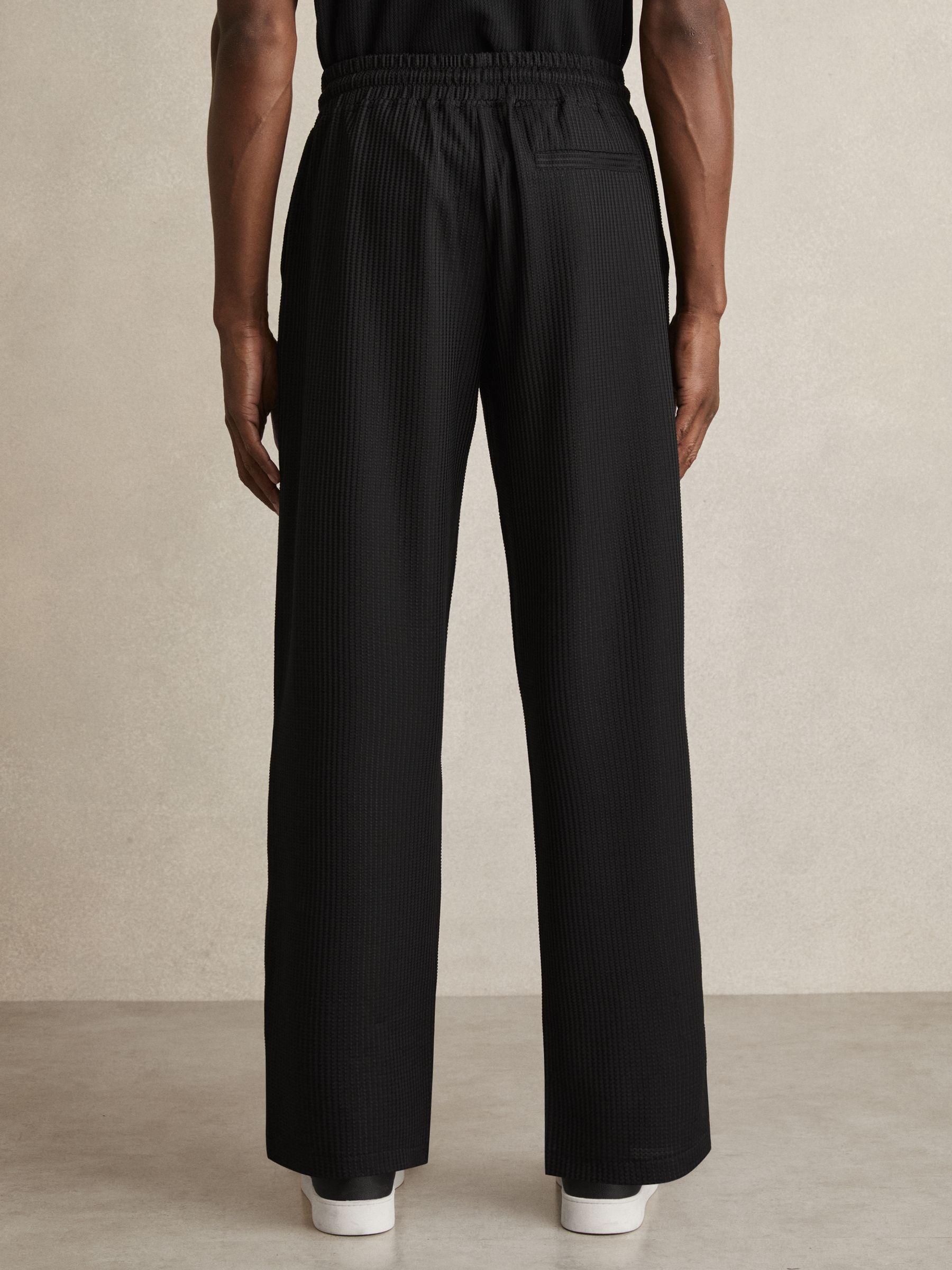 Textured-Knit Tapered Trousers in Black Product Image