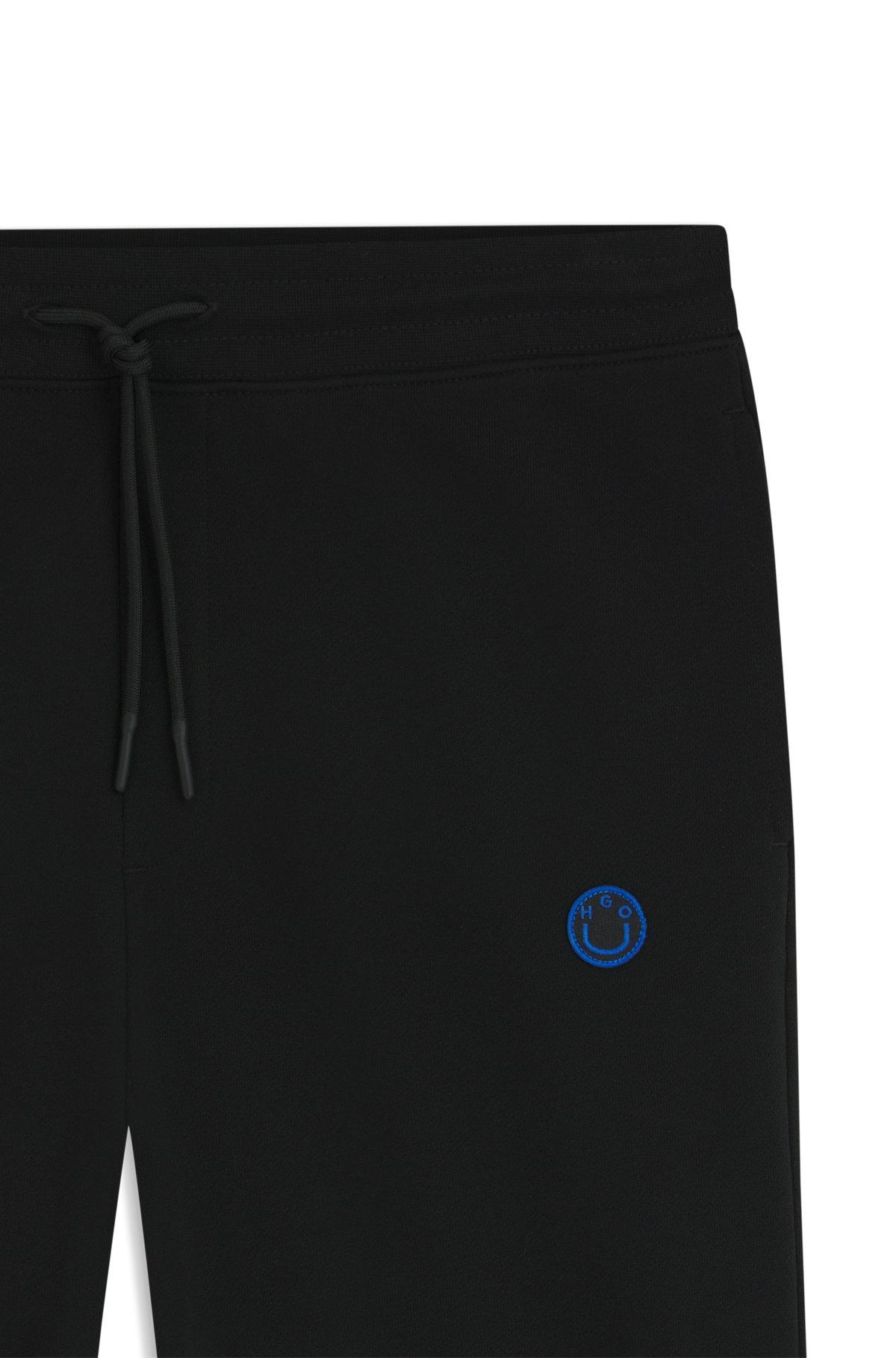 Cotton-terry tracksuit bottoms with Happy HUGO Product Image