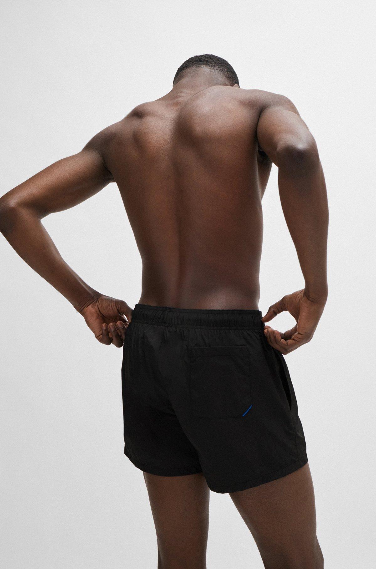 Partially lined quick-dry swim shorts with vertical logo Product Image