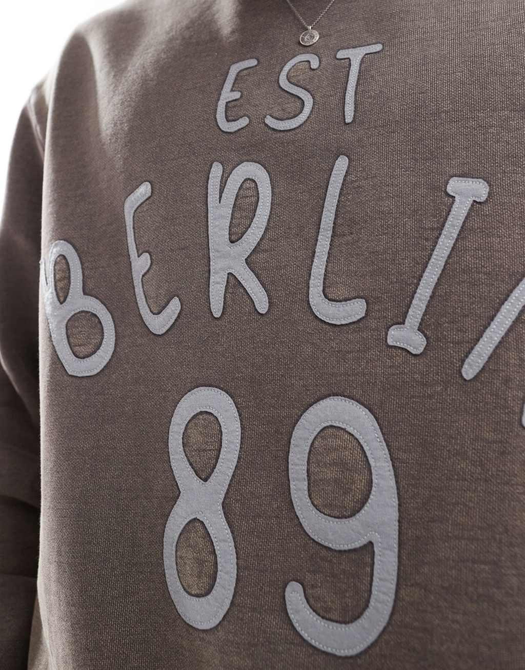 ASOS DESIGN oversized sweatshirt in acid wash with applique print in charcoal Product Image