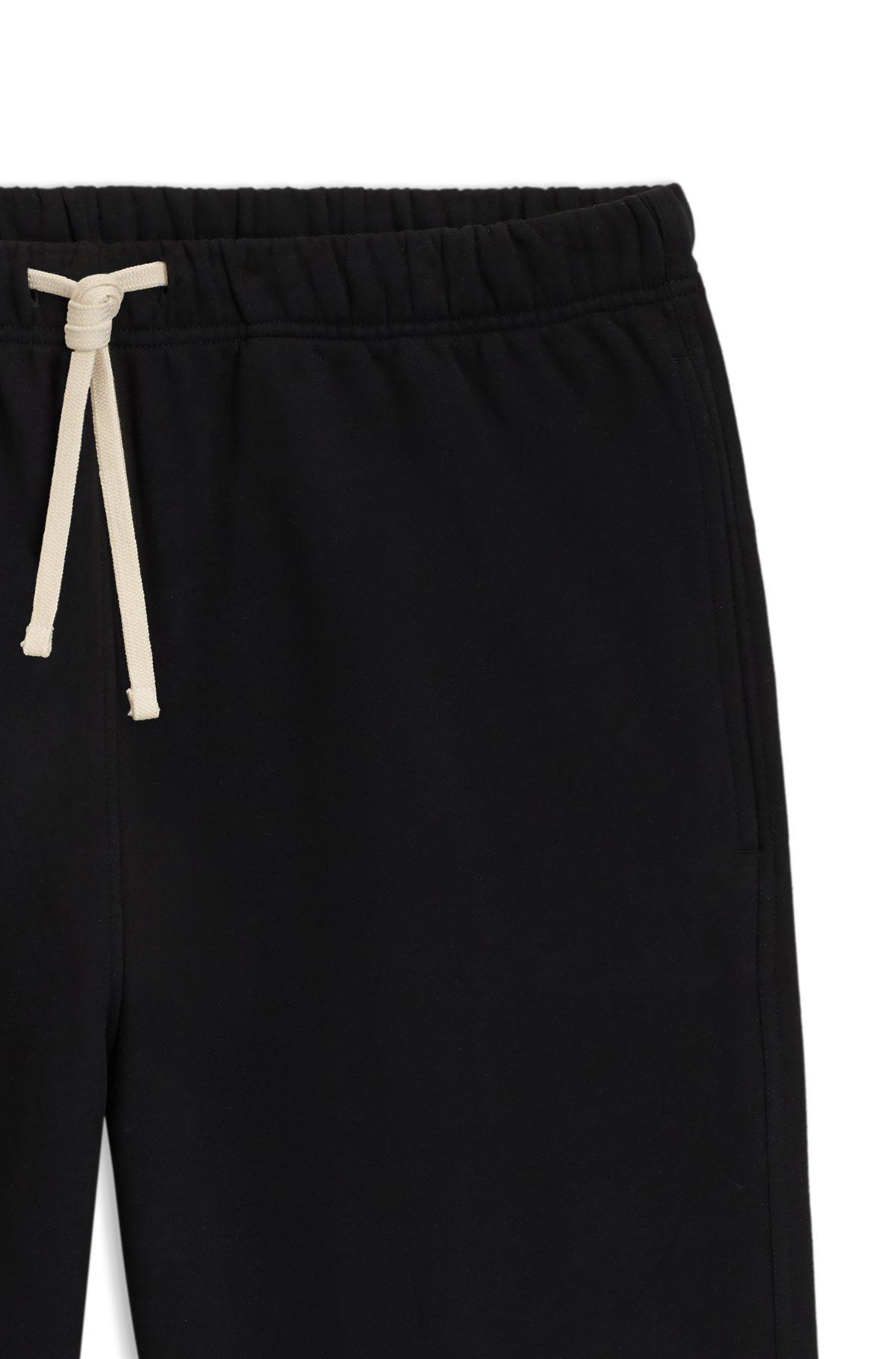 BOSS - BECKHAM x BOSS relaxed tracksuit bottoms in cotton terry - Black Product Image