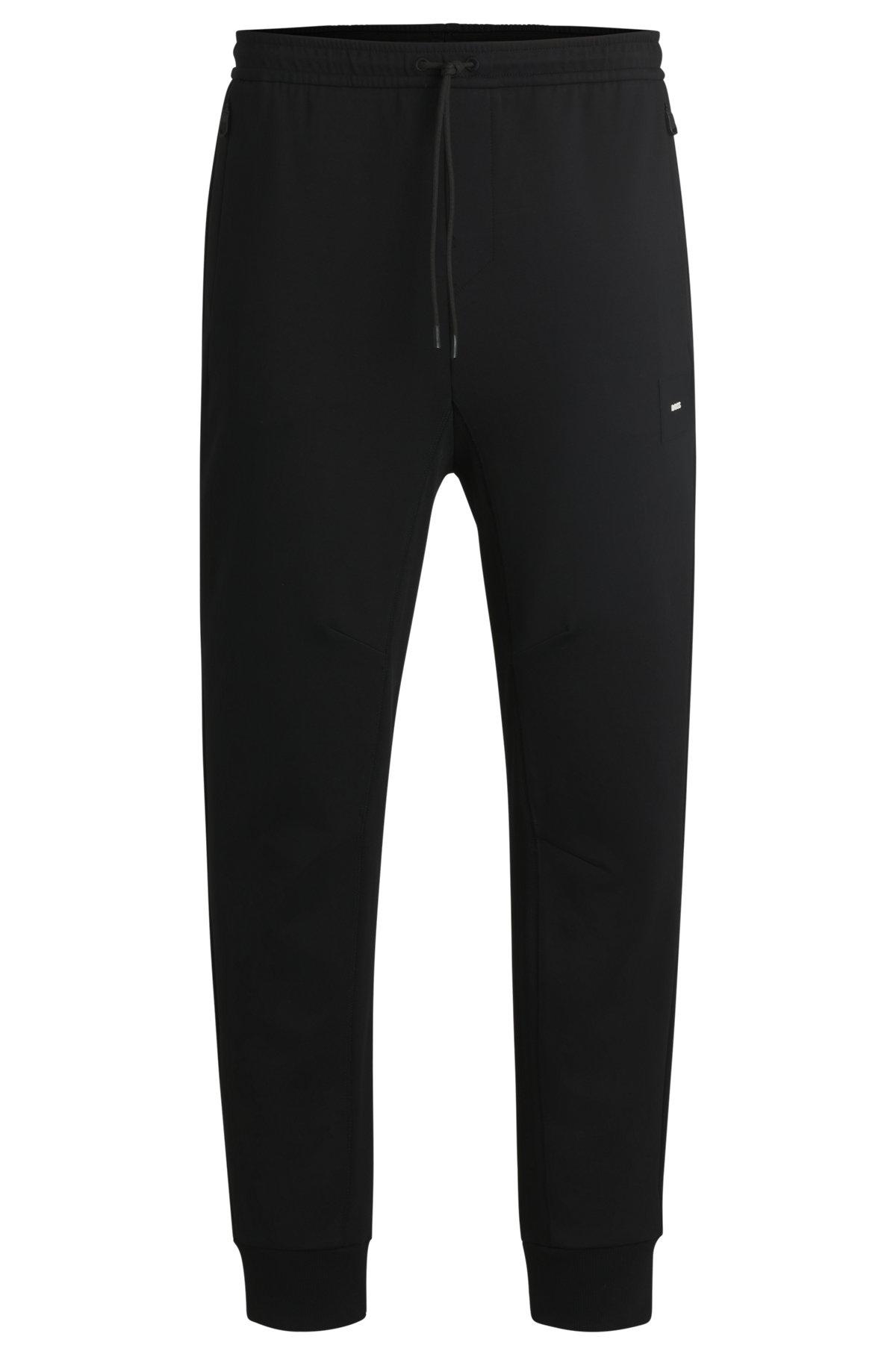 Stretch tracksuit bottoms with logo patch Product Image