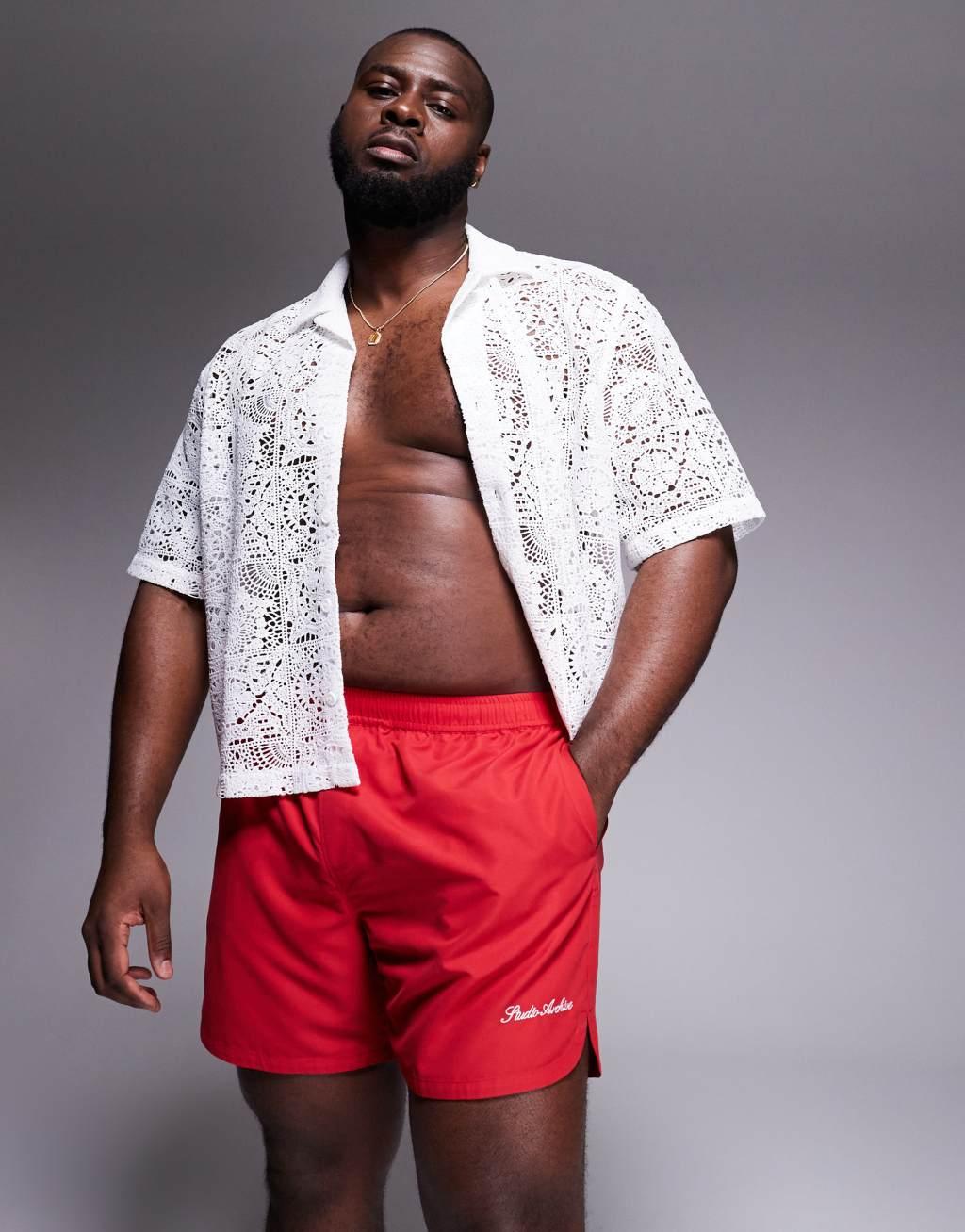 ASOS DESIGN swim shorts in mid length with embroidery in red Product Image