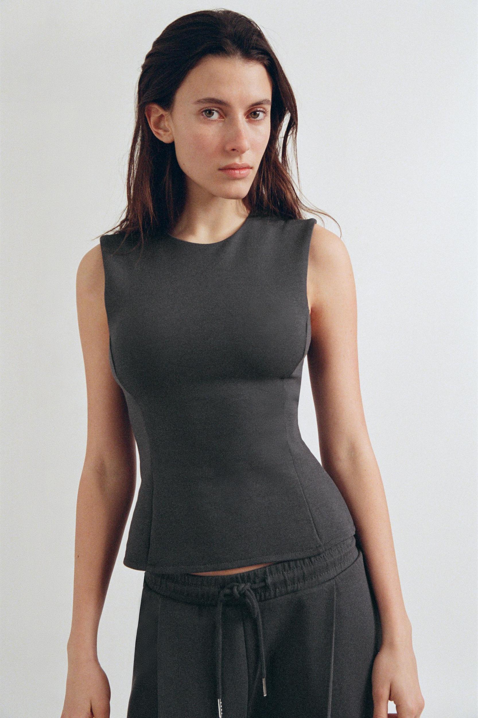 PEPLUM INTERLOCK TOP Product Image