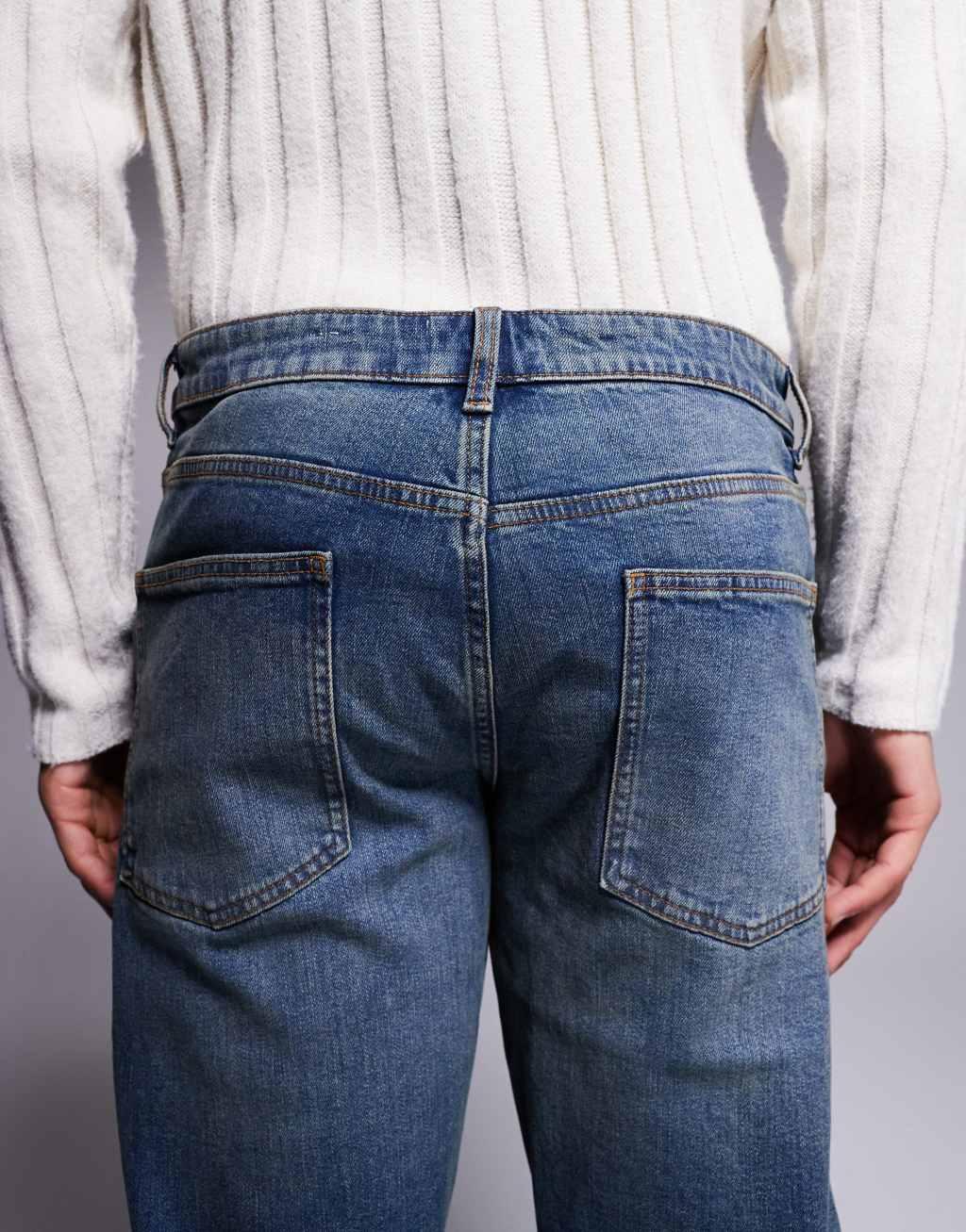 ASOS DESIGN stretch tapered jeans in mid wash with tint Product Image