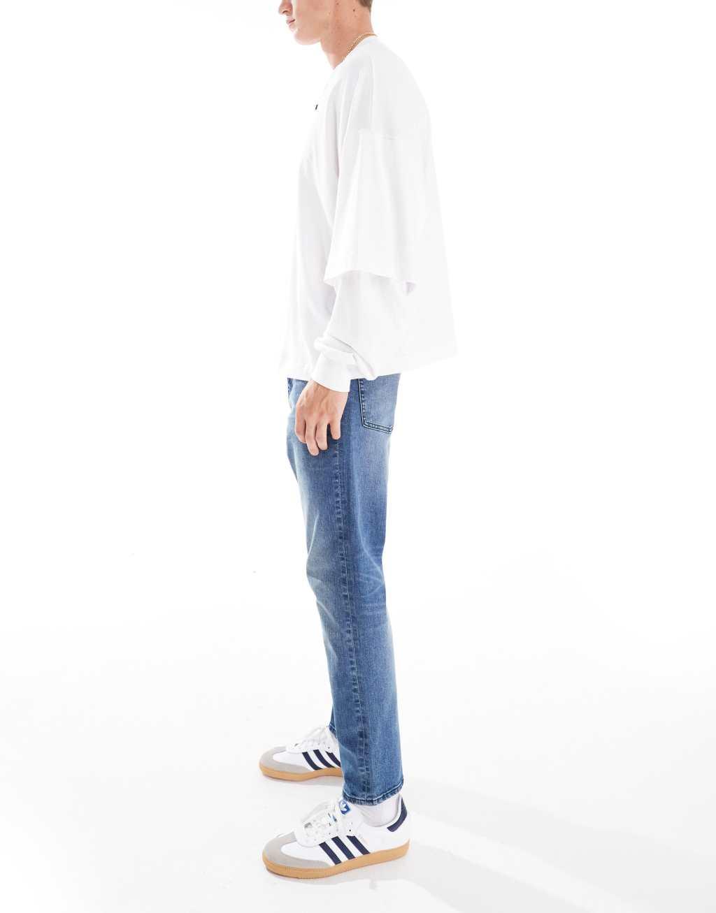 ASOS DESIGN slim jeans with tint in mid wash blue Product Image