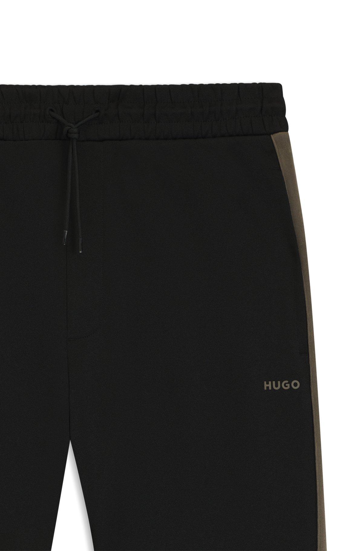 Relaxed-fit tracksuit bottoms with logo tape Product Image