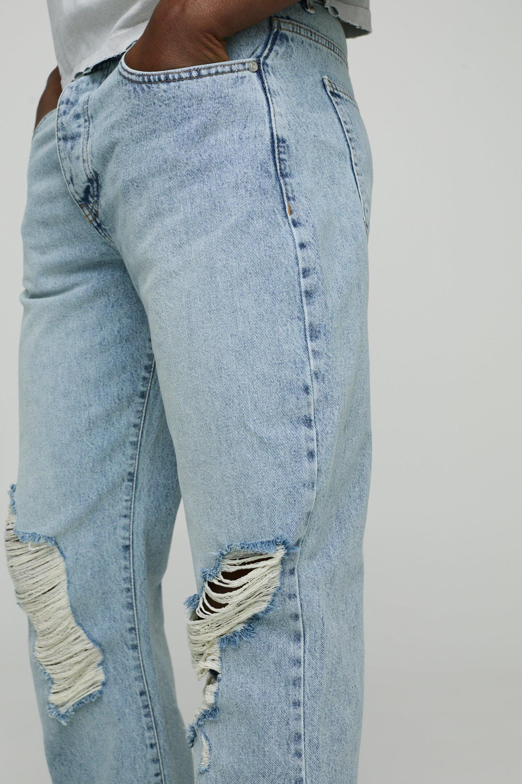 Relaxed Flare Ripped Knee Blue Wash Jeans | boohooMAN USA Product Image