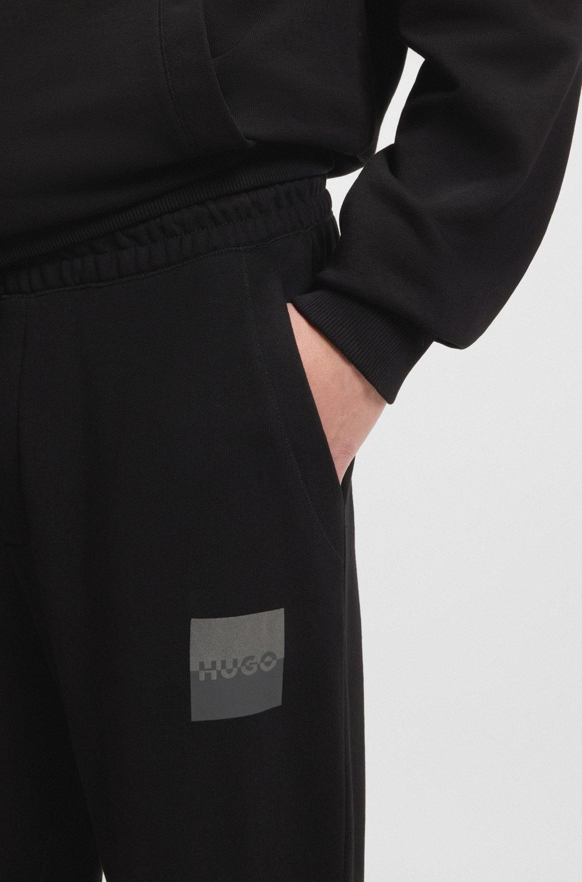 HUGO - Cotton-terry tracksuit bottoms with split logo - Black Product Image