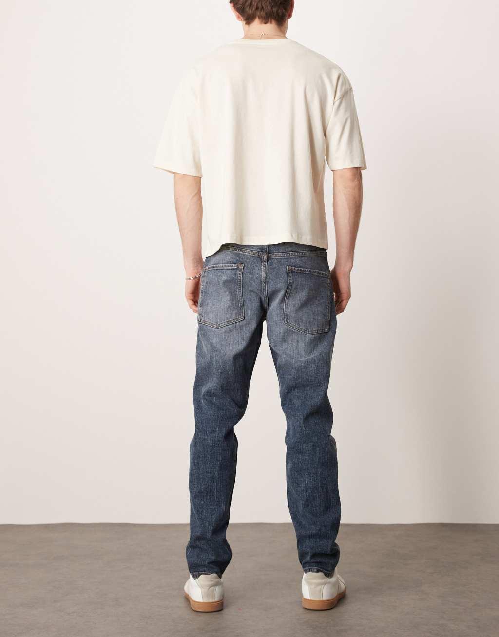 ASOS DESIGN stretch tapered jeans in mid wash blue Product Image