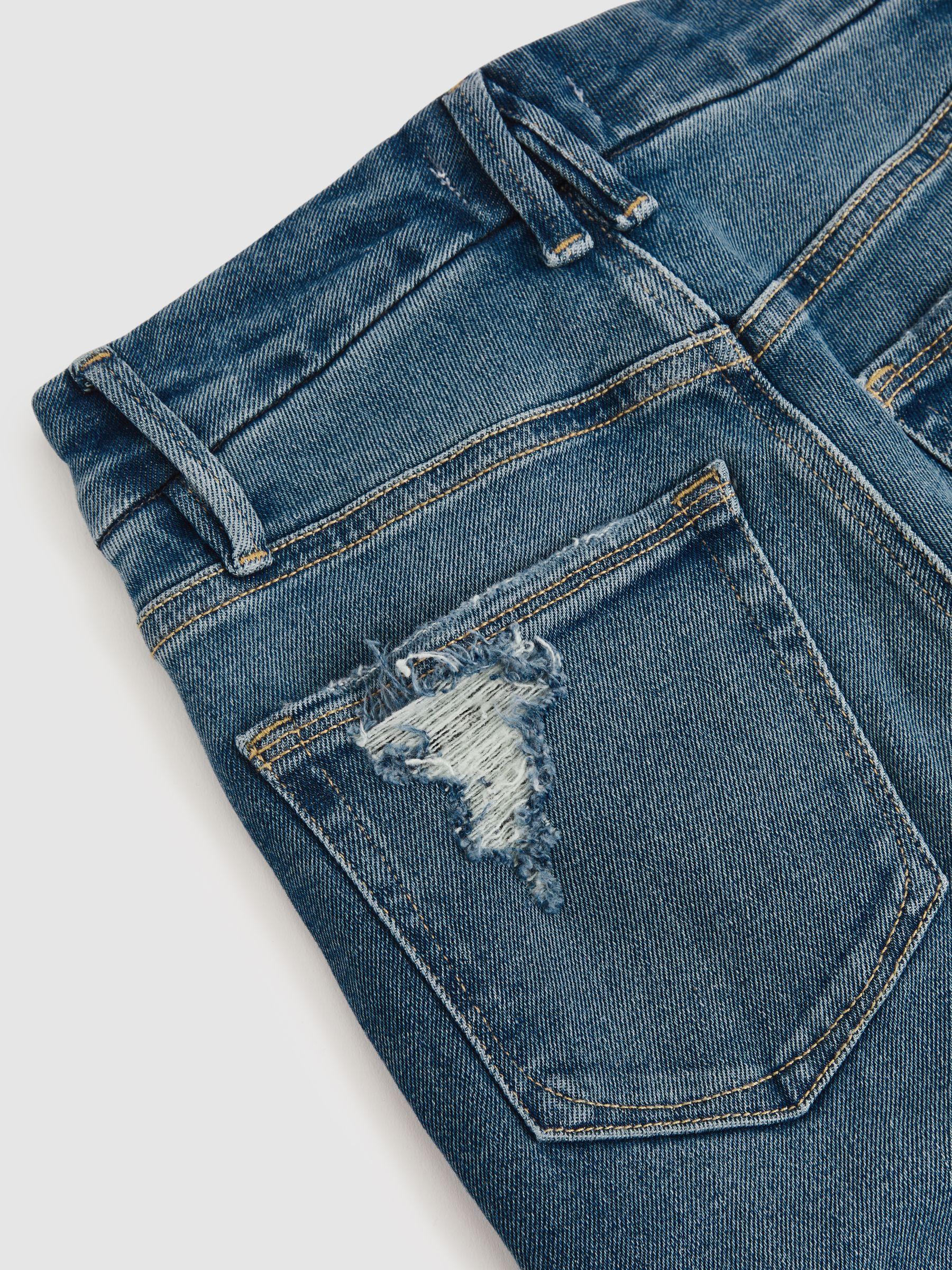 Good American Flared Distressed Jeans in Dark Indigo Product Image