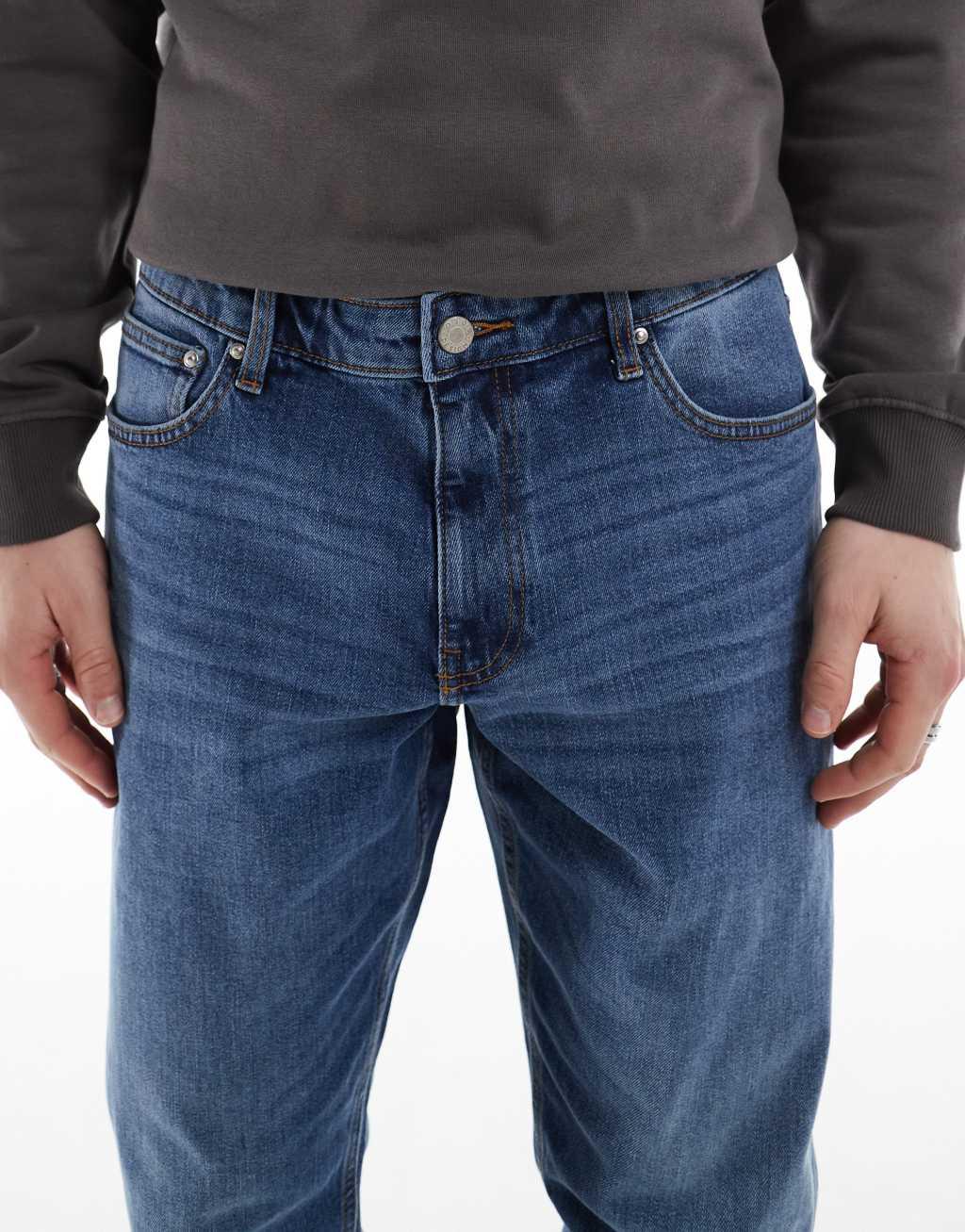 ASOS DESIGN stretch tapered jeans in mid wash Product Image