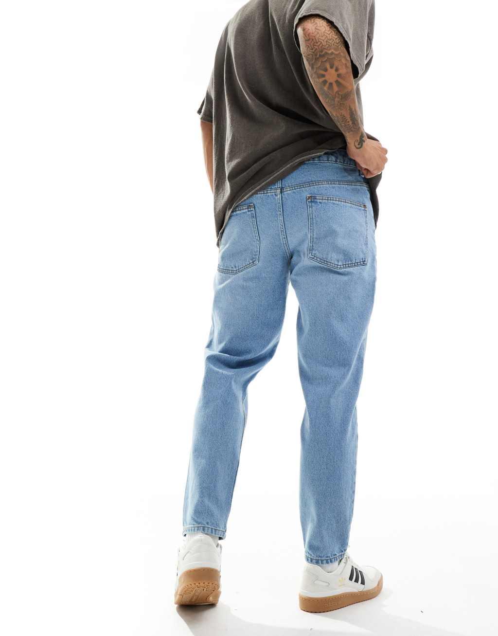 ASOS DESIGN tapered fit jeans in light wash blue  Product Image