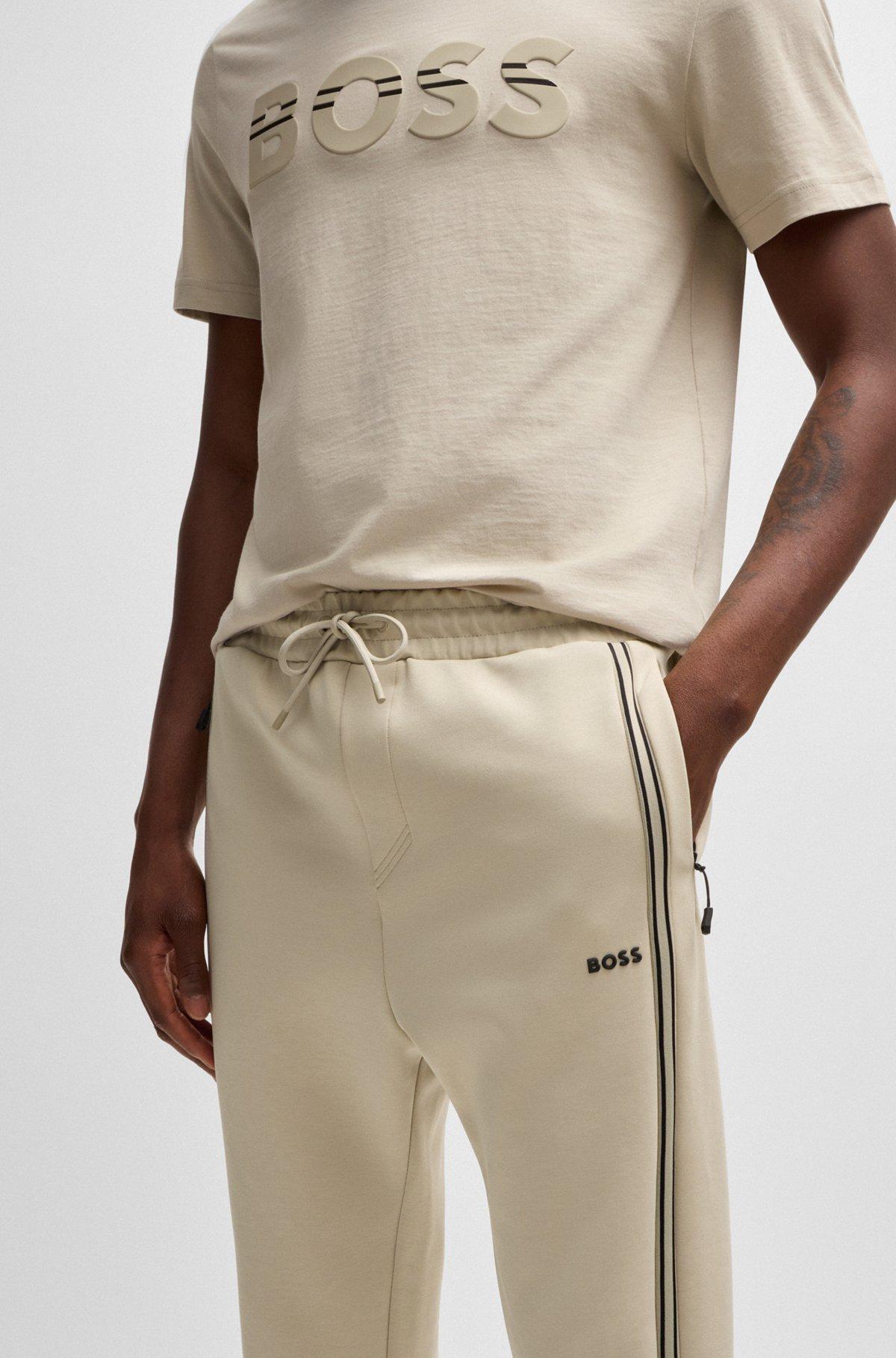 Tracksuit bottoms with tape inserts Product Image