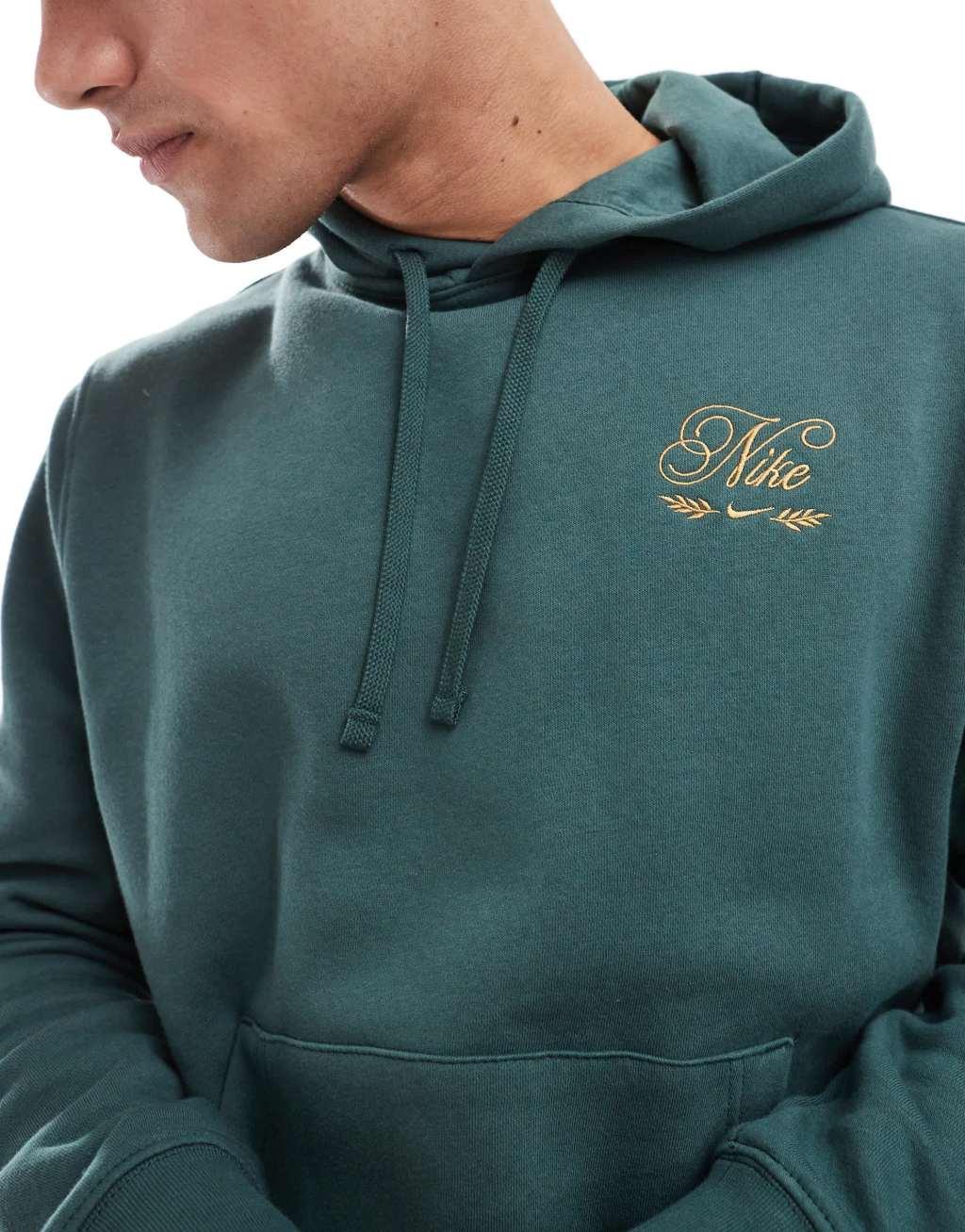 Nike 'Tis The Season logo hoodie in dark green Product Image