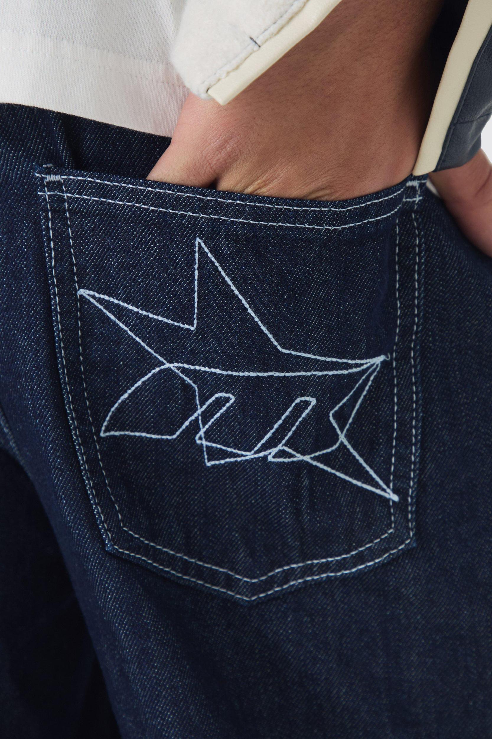Relaxed Rigid Indigo Contrast Embroidered Strap Cuffed Jeans | boohooMAN USA Product Image