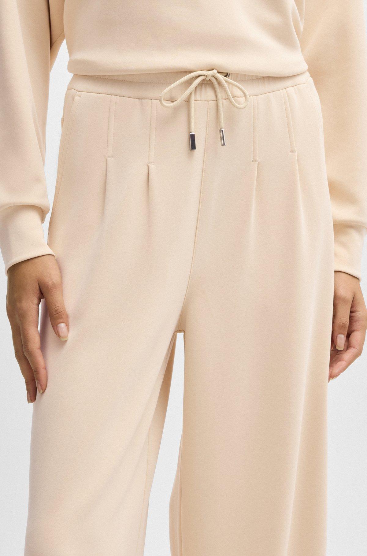 Wide-leg tracksuit bottoms with pleat details Product Image