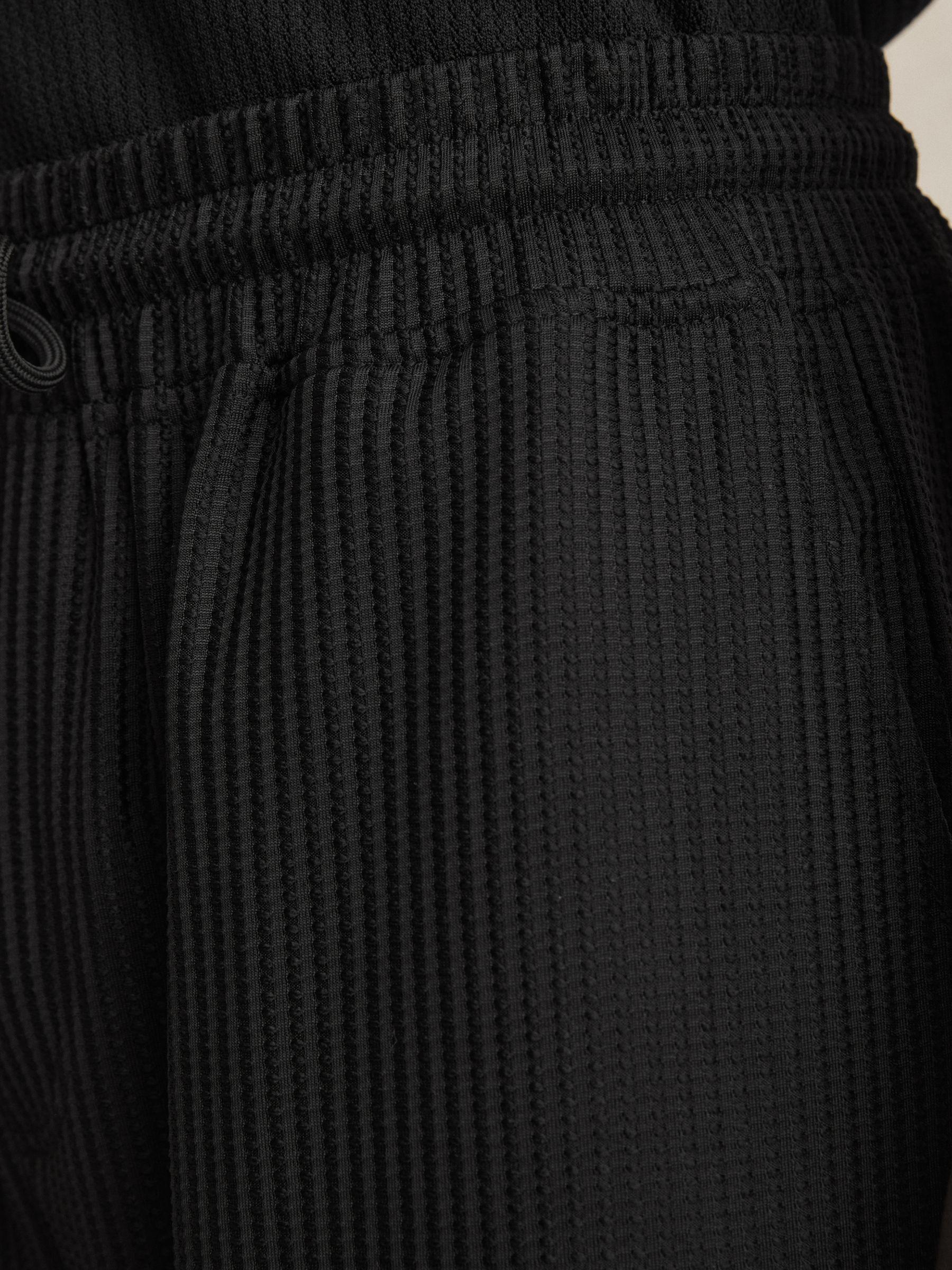 Textured-Knit Tapered Trousers in Black Product Image