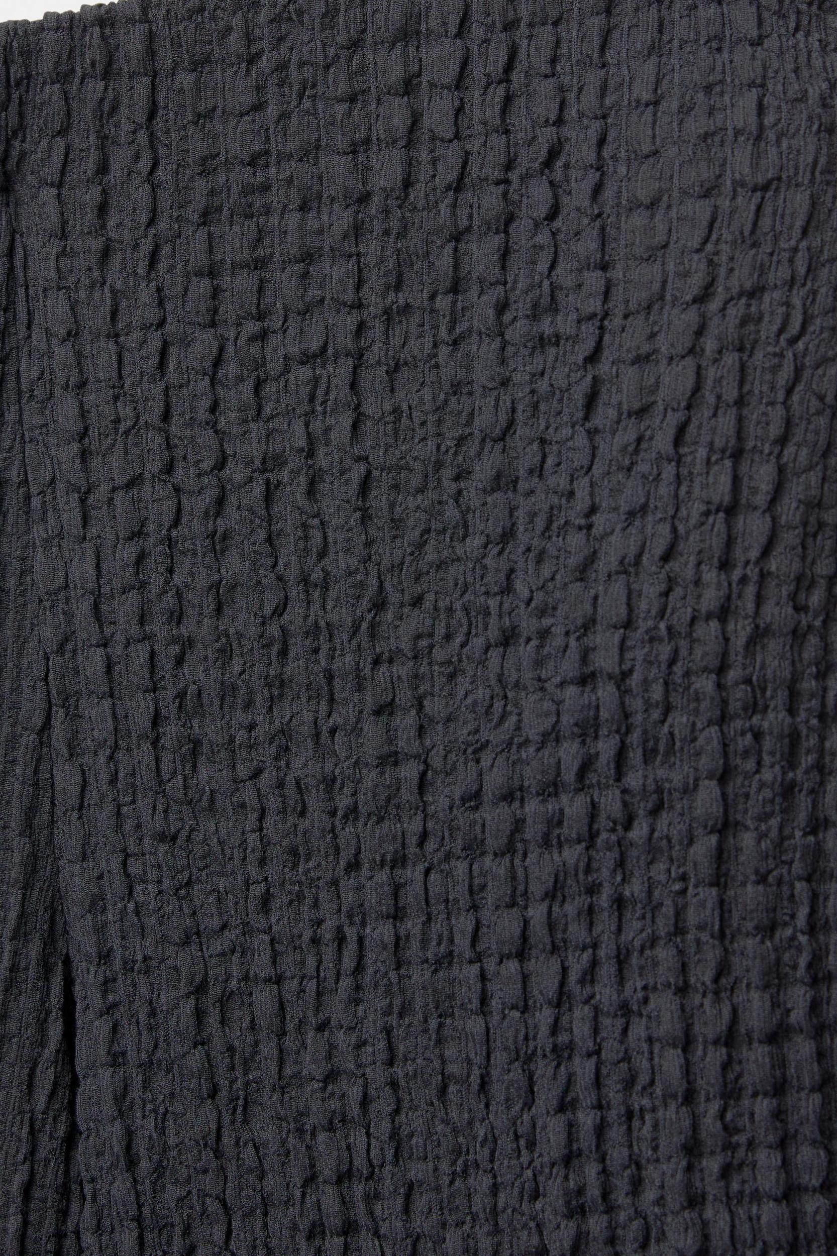 Rustic creased-effect pants Product Image