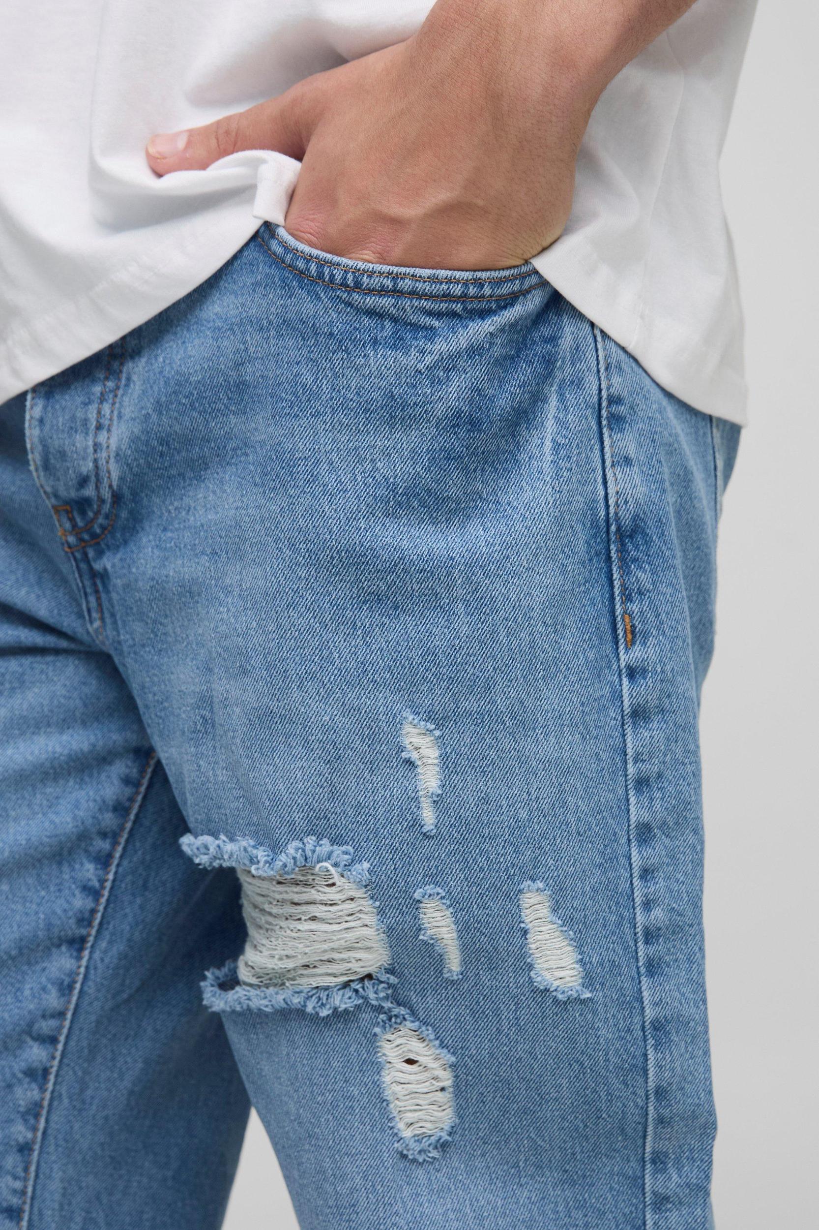 Relaxed Flared Ripped Knee Blue Wash Jeans | boohooMAN USA Product Image