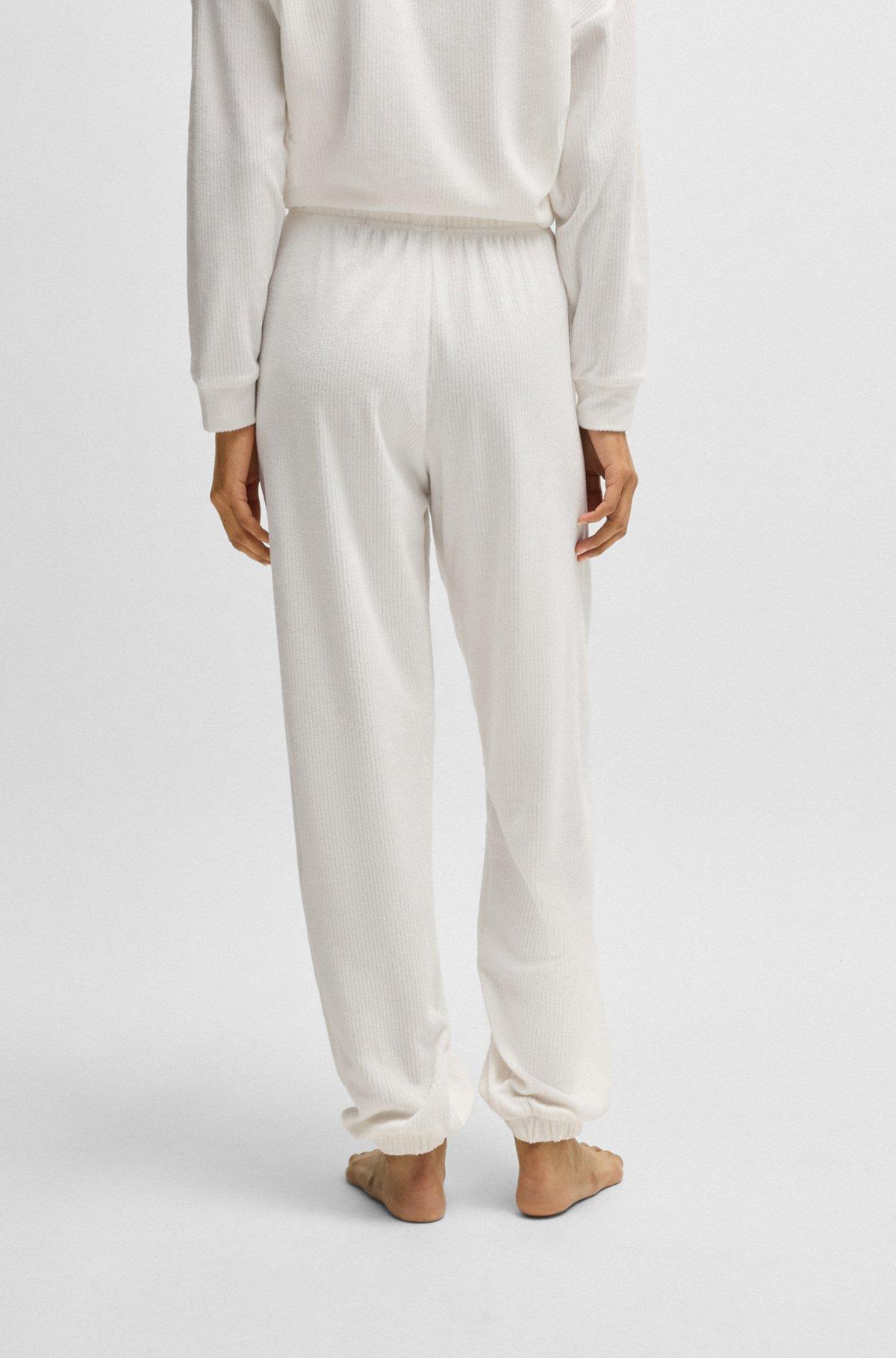 Tracksuit bottoms with red logo label Product Image