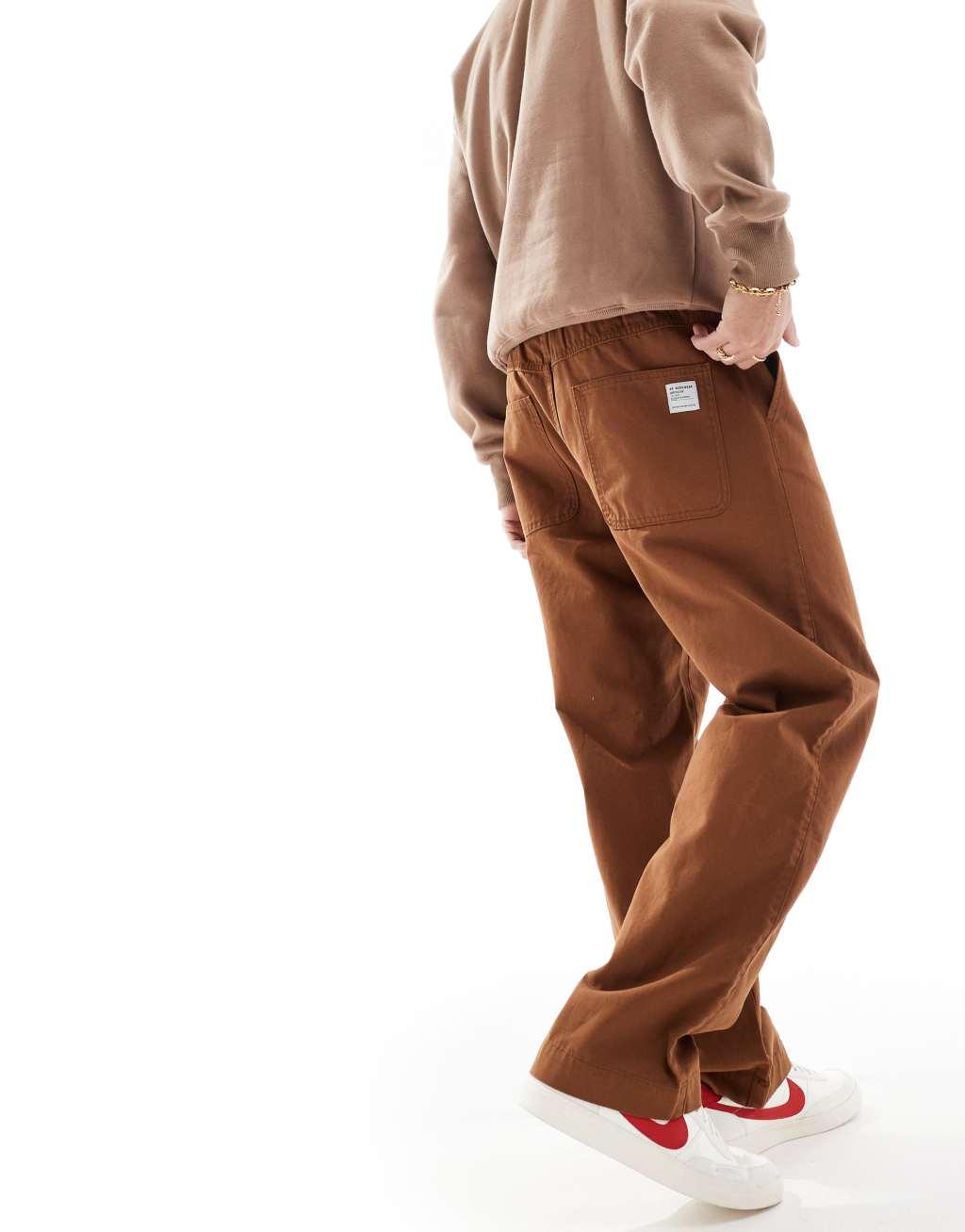 ASOS DESIGN baggy pull on pants with back pocket patch in brown Product Image