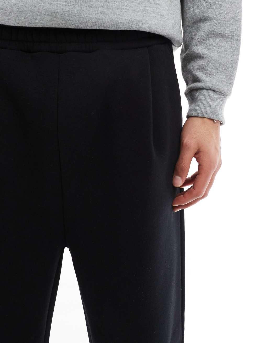 ASOS DESIGN oversized balloon sweatpants with pleat in black Product Image
